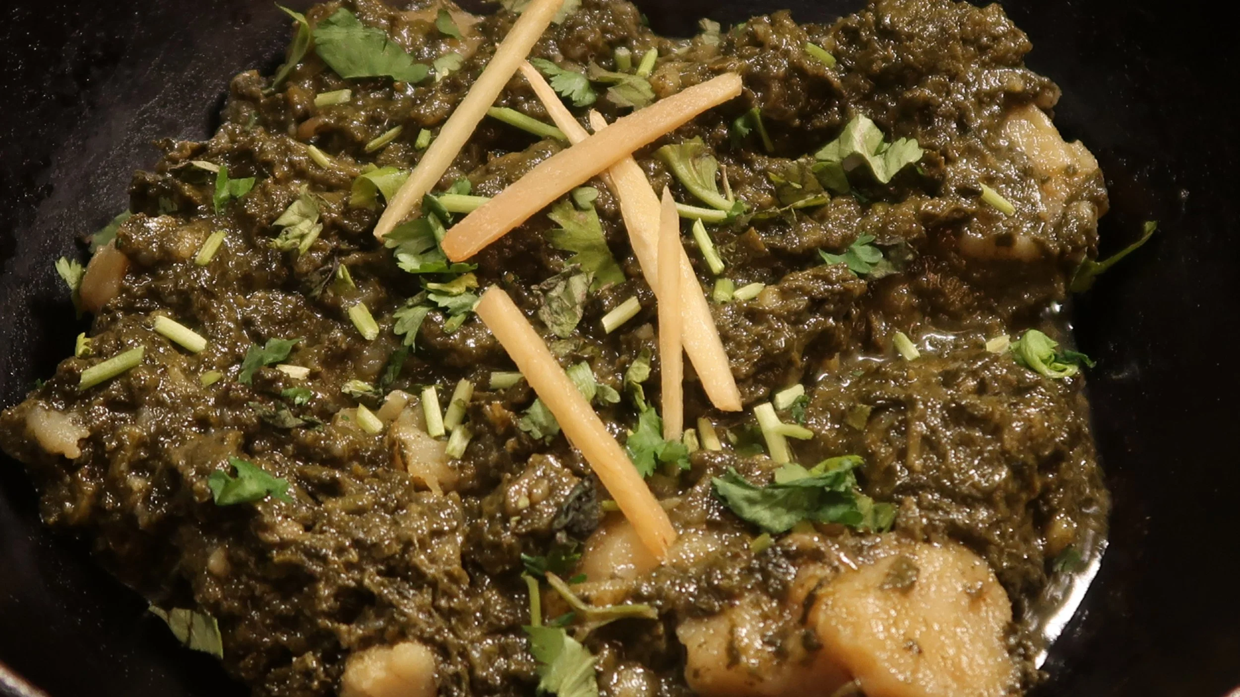 Saag Aloo | Spinach cooked with potatoes in our special spices.