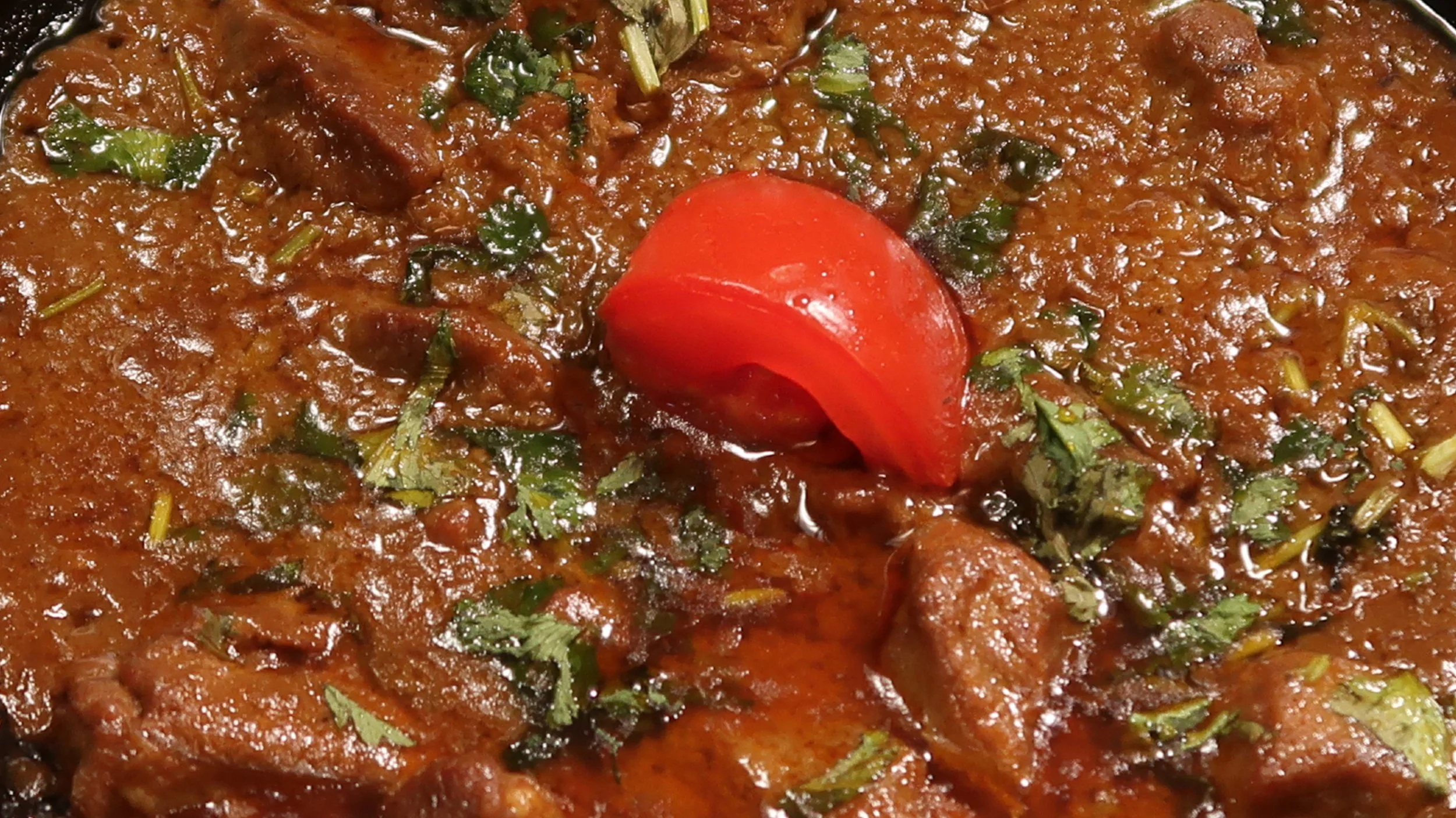 Karahi Gosht | Hand-prepared, diced lamb cooked with garlic, ginger, onions, tomatoes and spices.