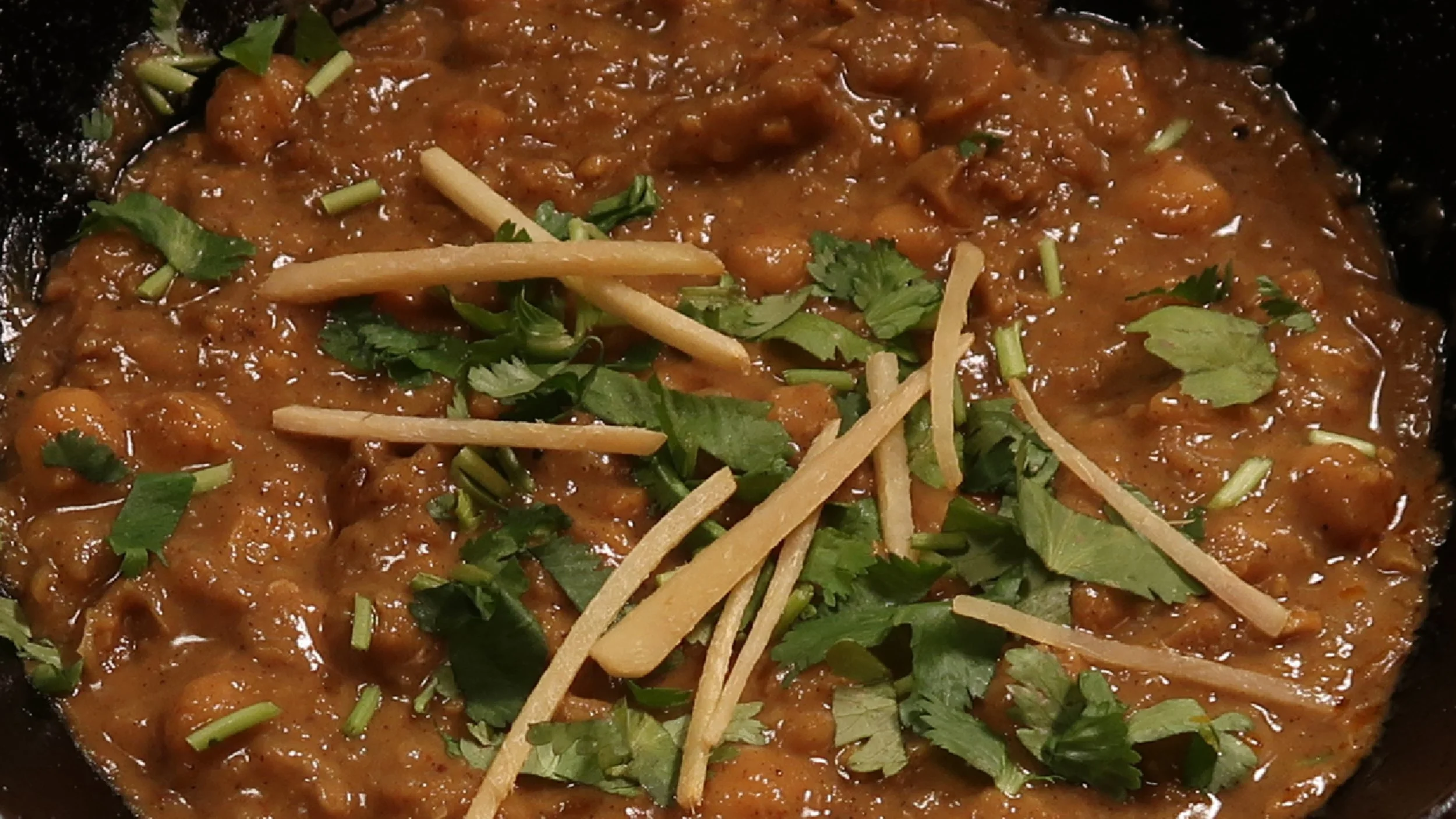 Channa | Our world famous, signature dish. Soft chickpeas cooked with herbs and spices. Garnished with fresh ginger and coriander