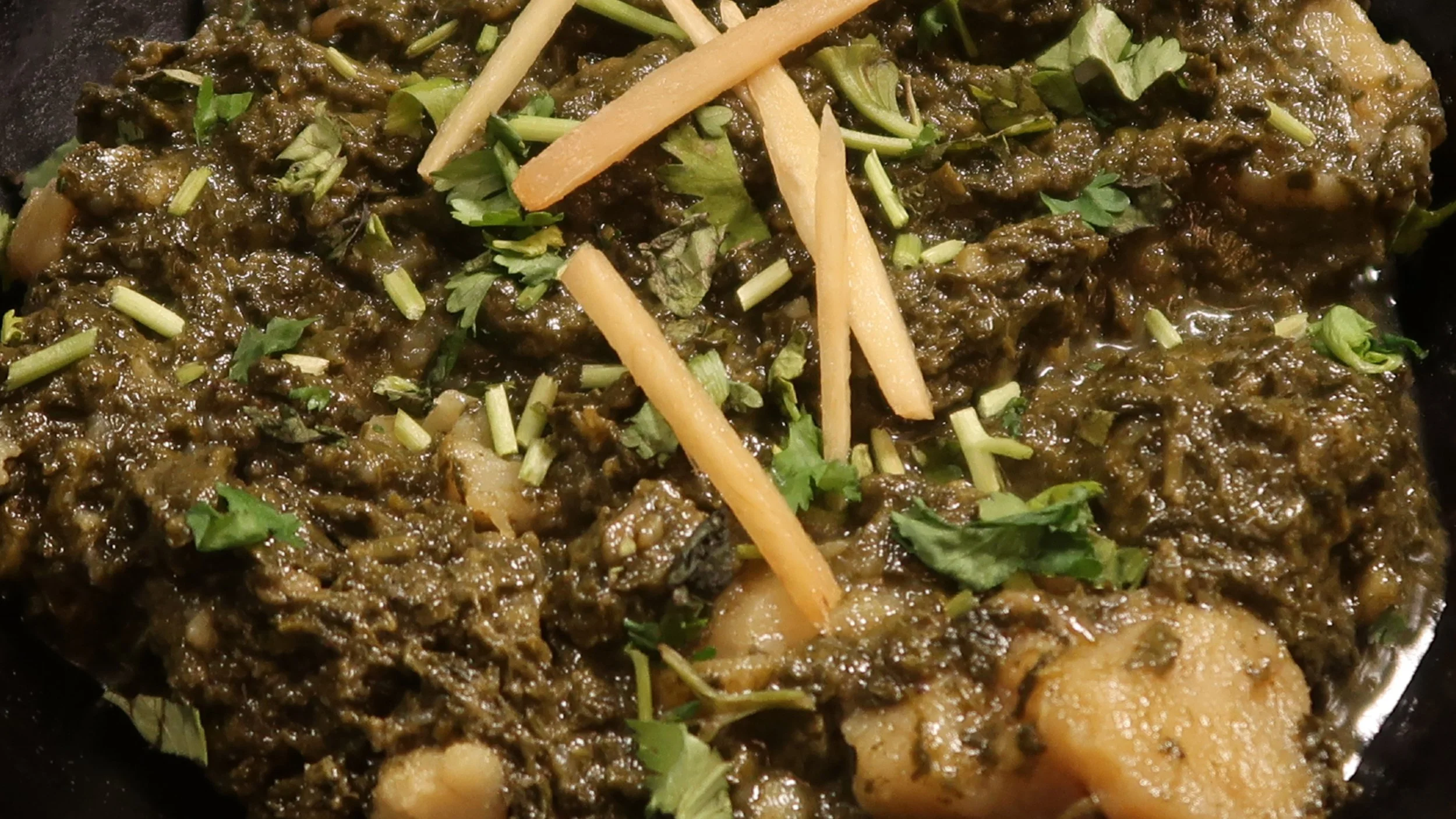 Saag Aloo | Spinach cooked with potatoes in our special spices.