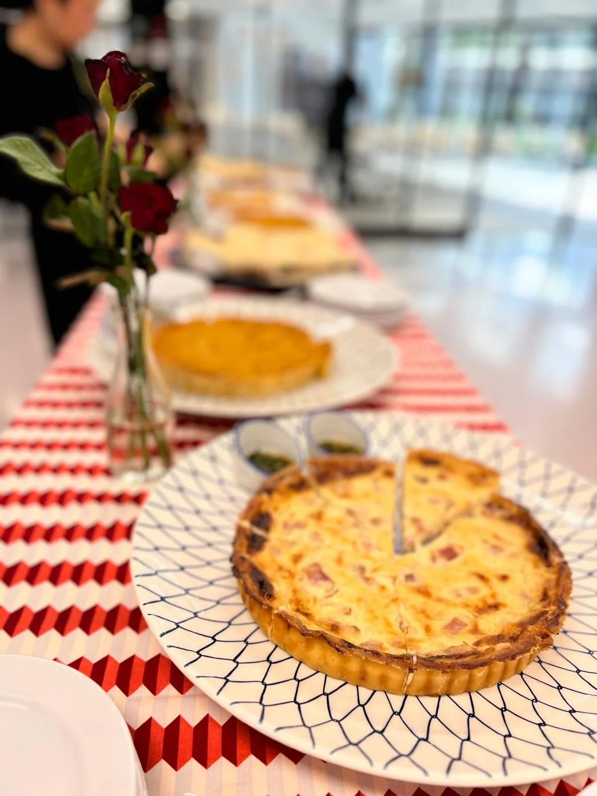 Quiches, sandwiches and roses on a Mornii catering table