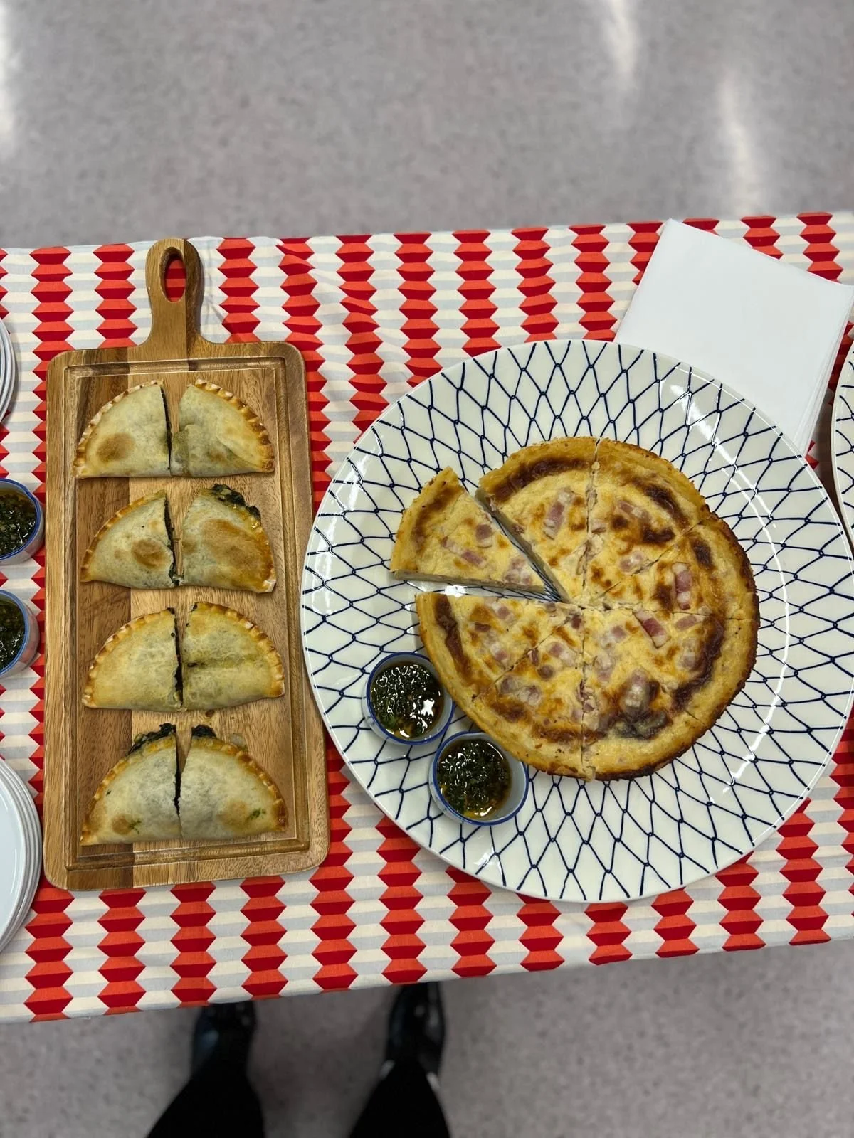 Spinach empanadas and a ham and cheese quiche with chimichurri, from above