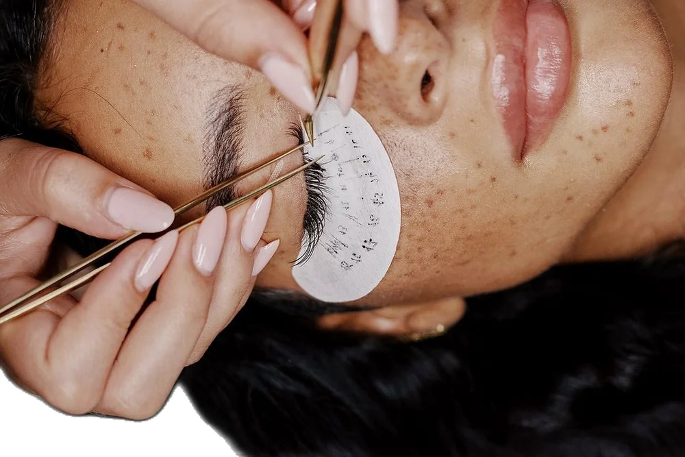 Lash extensions applied with tweezers and an under-eye pad
