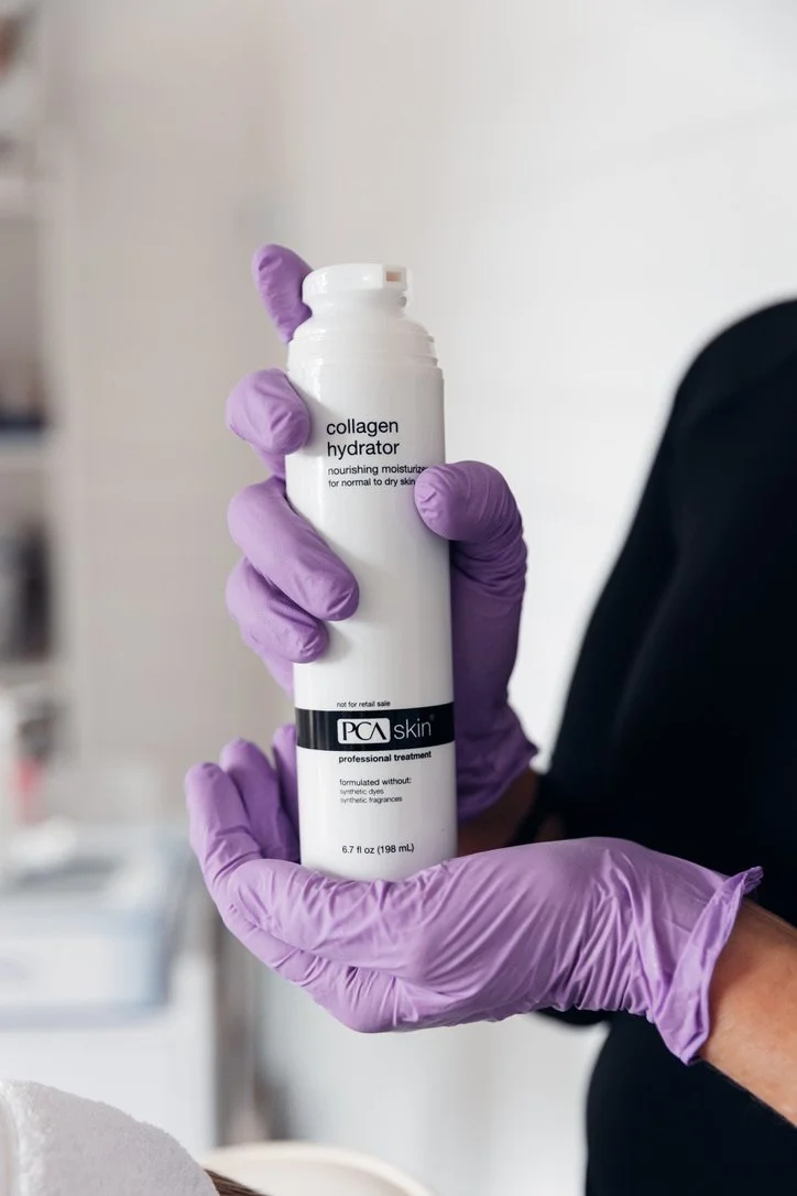 An image of a female hand holding up an advanced skincare product designed to improve pigmentation and brighten skin located at a skin clinic in bournemouth