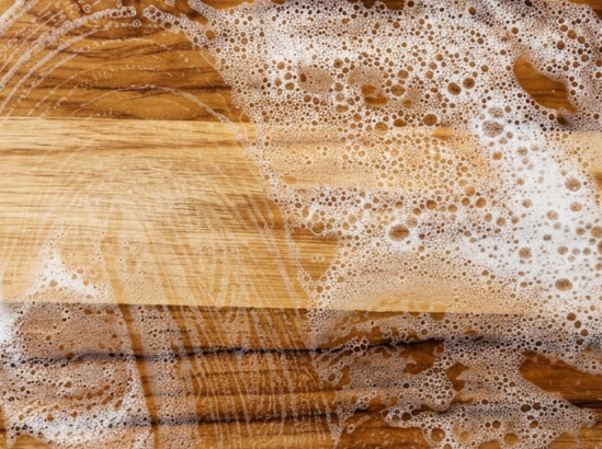 Wooden surface with soap suds and bubbles.