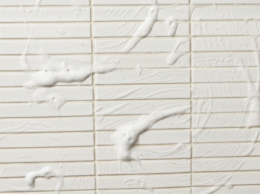 White wall with paint or plaster splattered across it.
