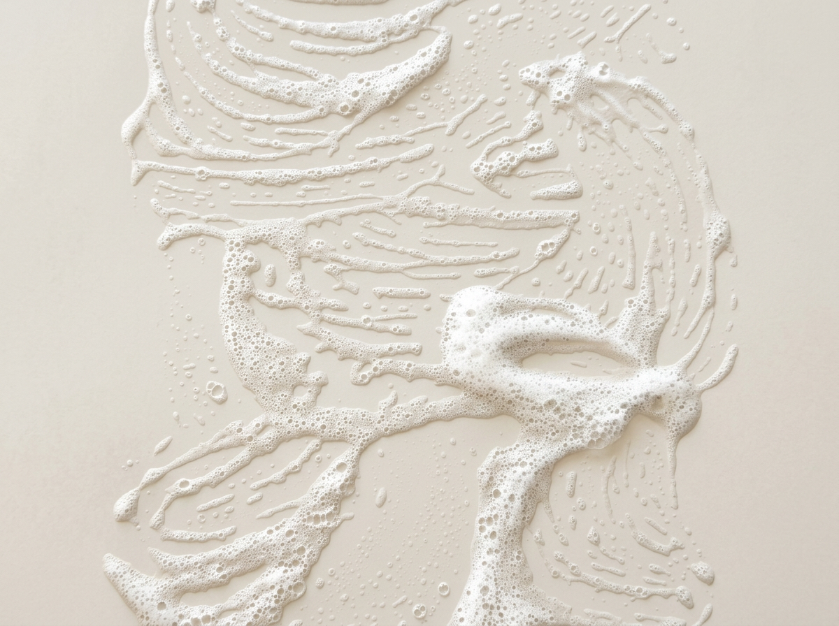 Foamy soap arranged to resemble cellular or molecular structures on a beige background.