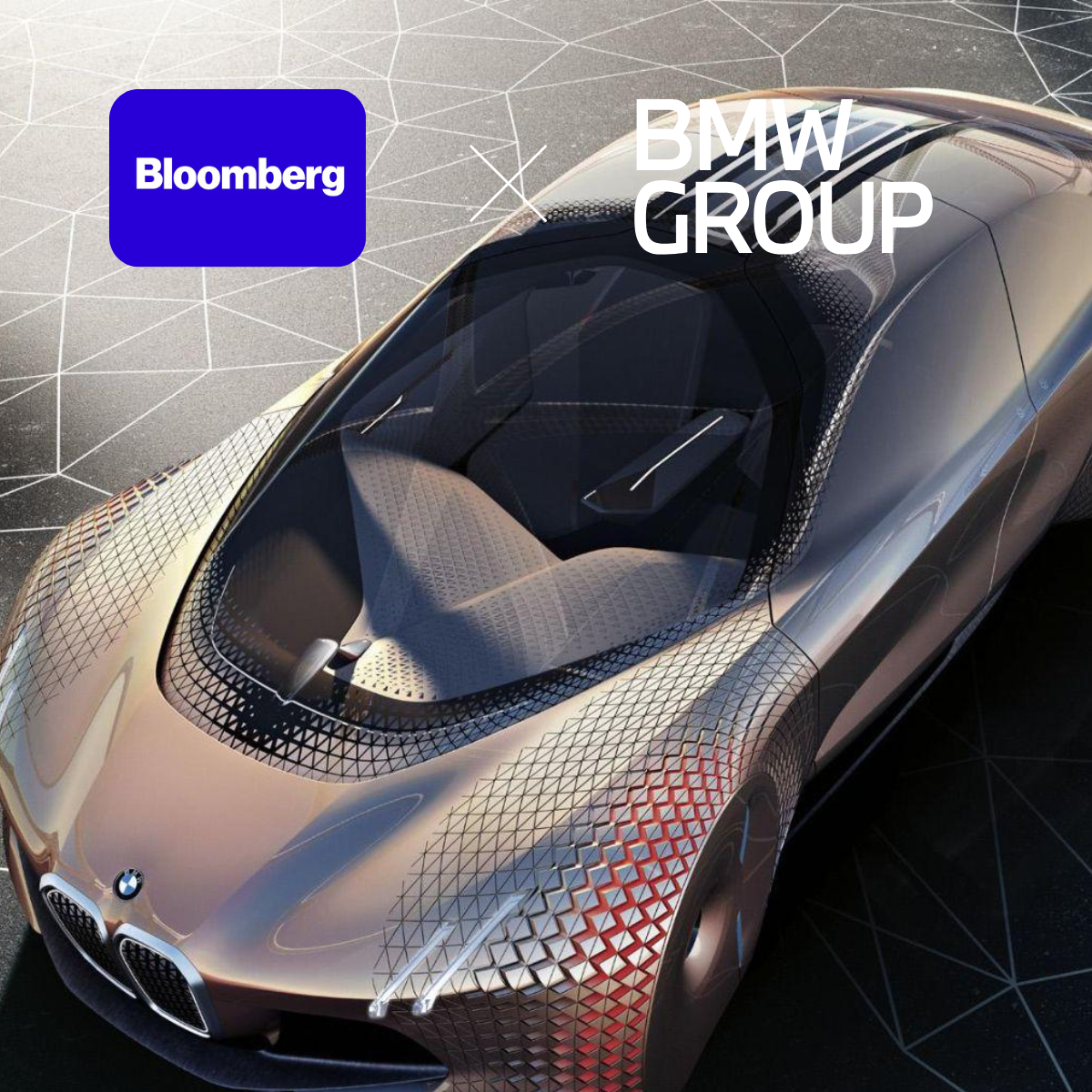 A sleek, futuristic BMW concept car with a gold exterior and geometric patterns, viewed from above. The image includes the BMW GROUP logo and Bloomberg branding.