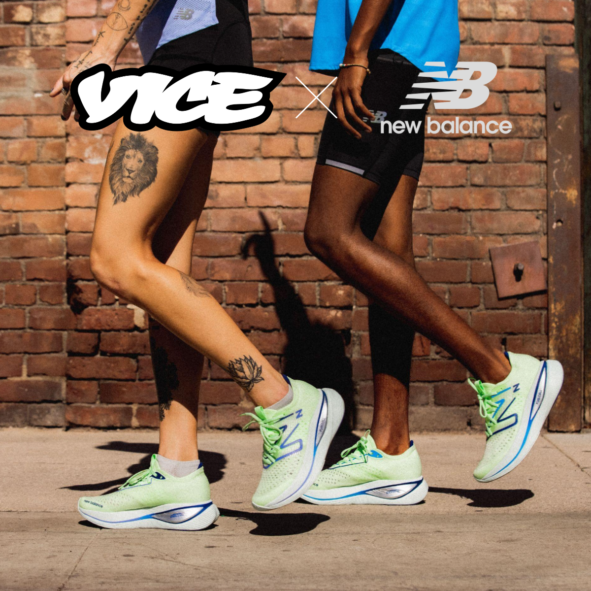 Two people wearing New Balance running shoes, standing and walking in front of a brick wall.