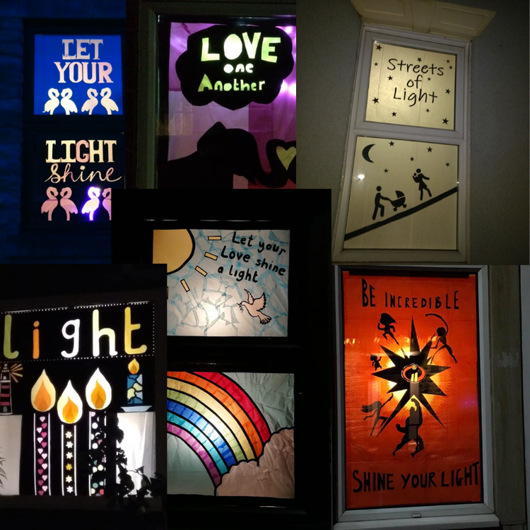 Collection of illuminated signs and windows with inspirational quotes and images, including candles, a rainbow, a whale, and silhouettes of people.