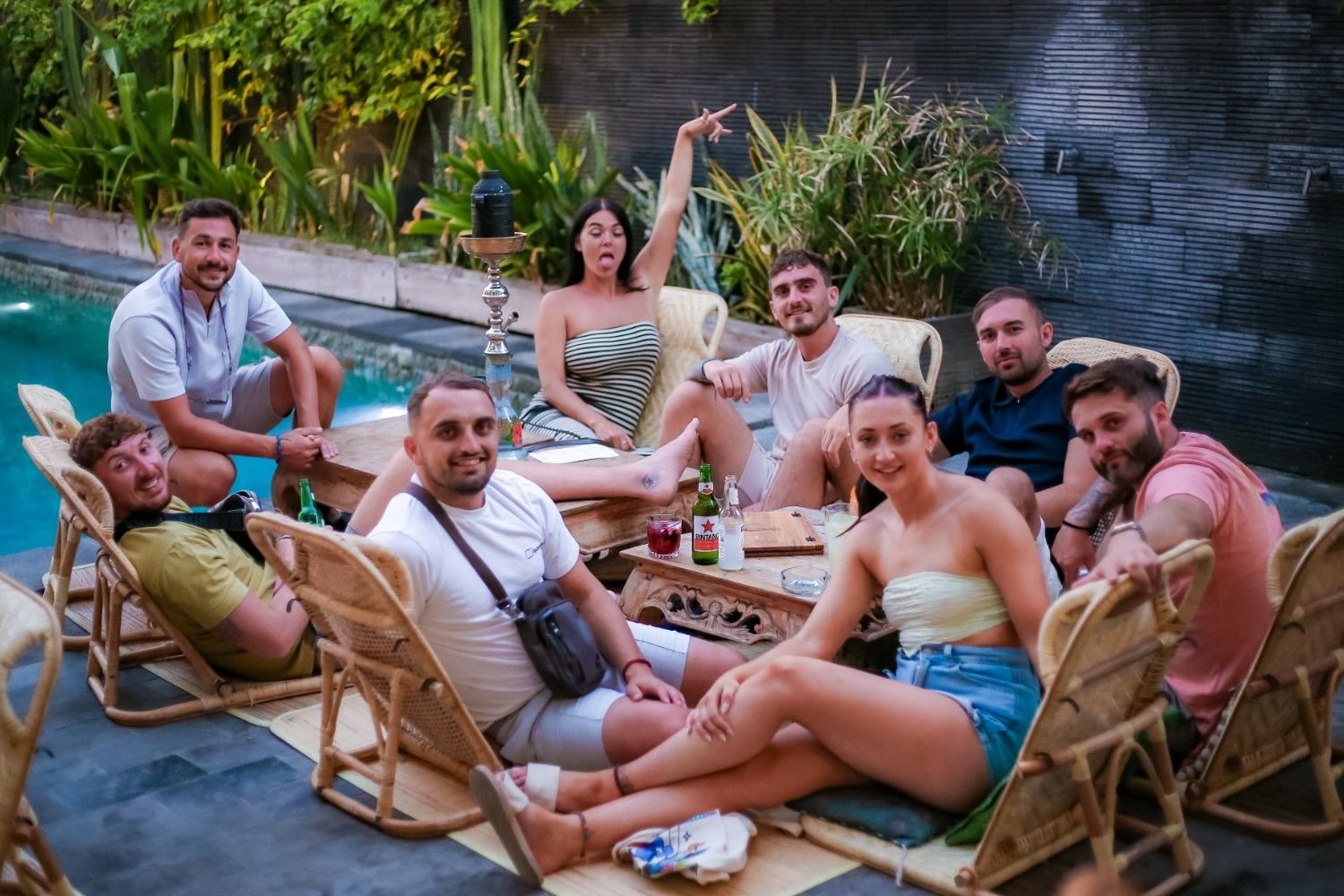 Guests relaxing by the swimming pool at Pesona Beach Resort in Gili Trawangan, enjoying drinks and a social afternoon