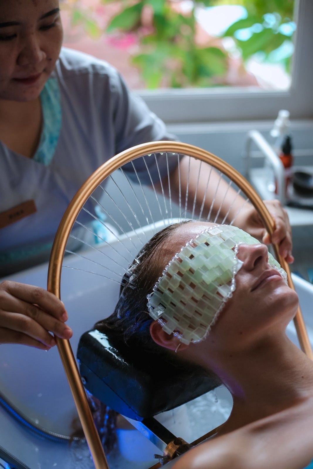 Guest enjoying a relaxing hair spa treatment at Azure Wellness Spa in Gili Trawangan with a nourishing hair mask and scalp therapy