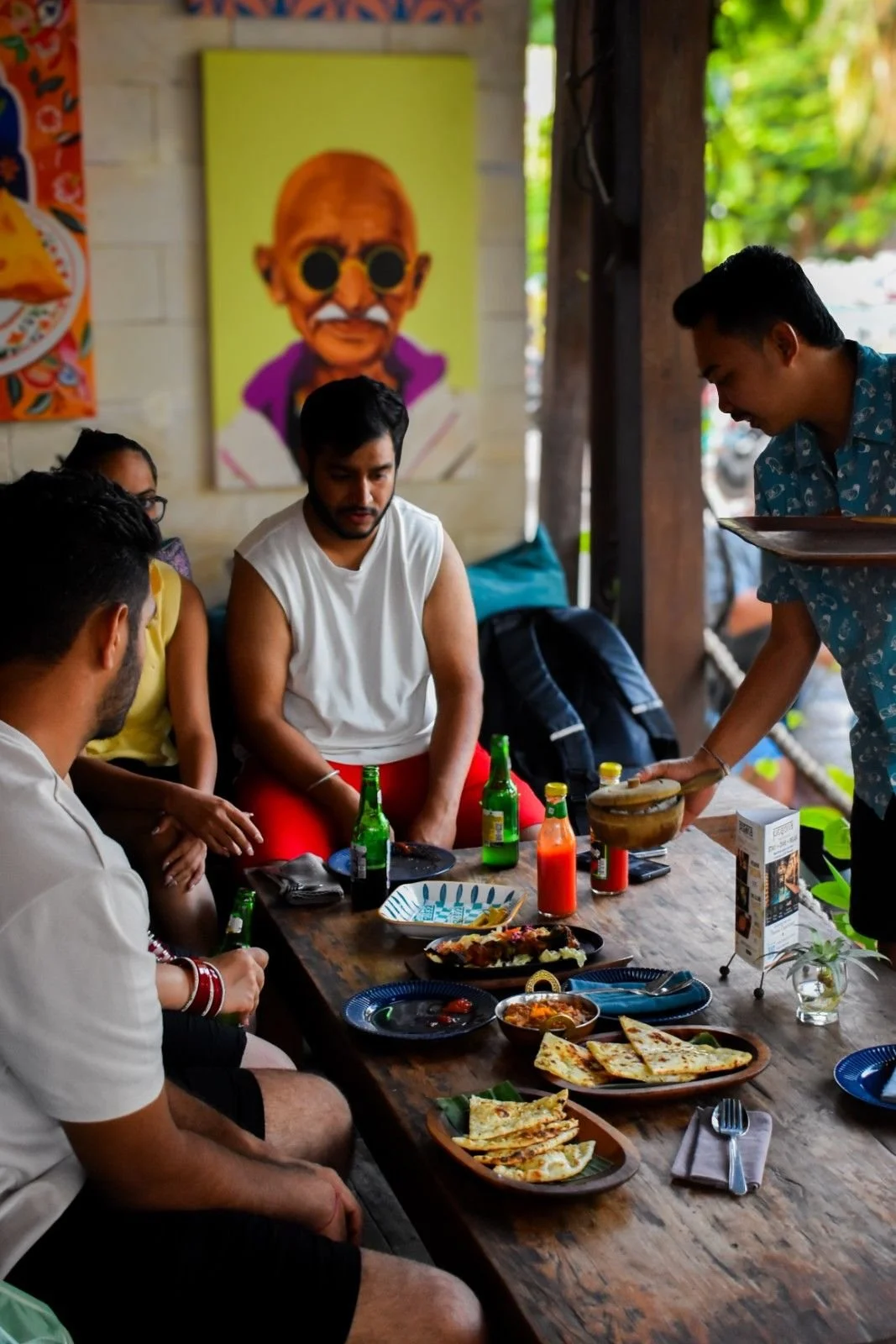Guests enjoying a meal together at Pesona Lounge Trawangan, the beachfront restaurant inside Pesona Beach Resort & Spa in Gili Trawangan, Lombok.