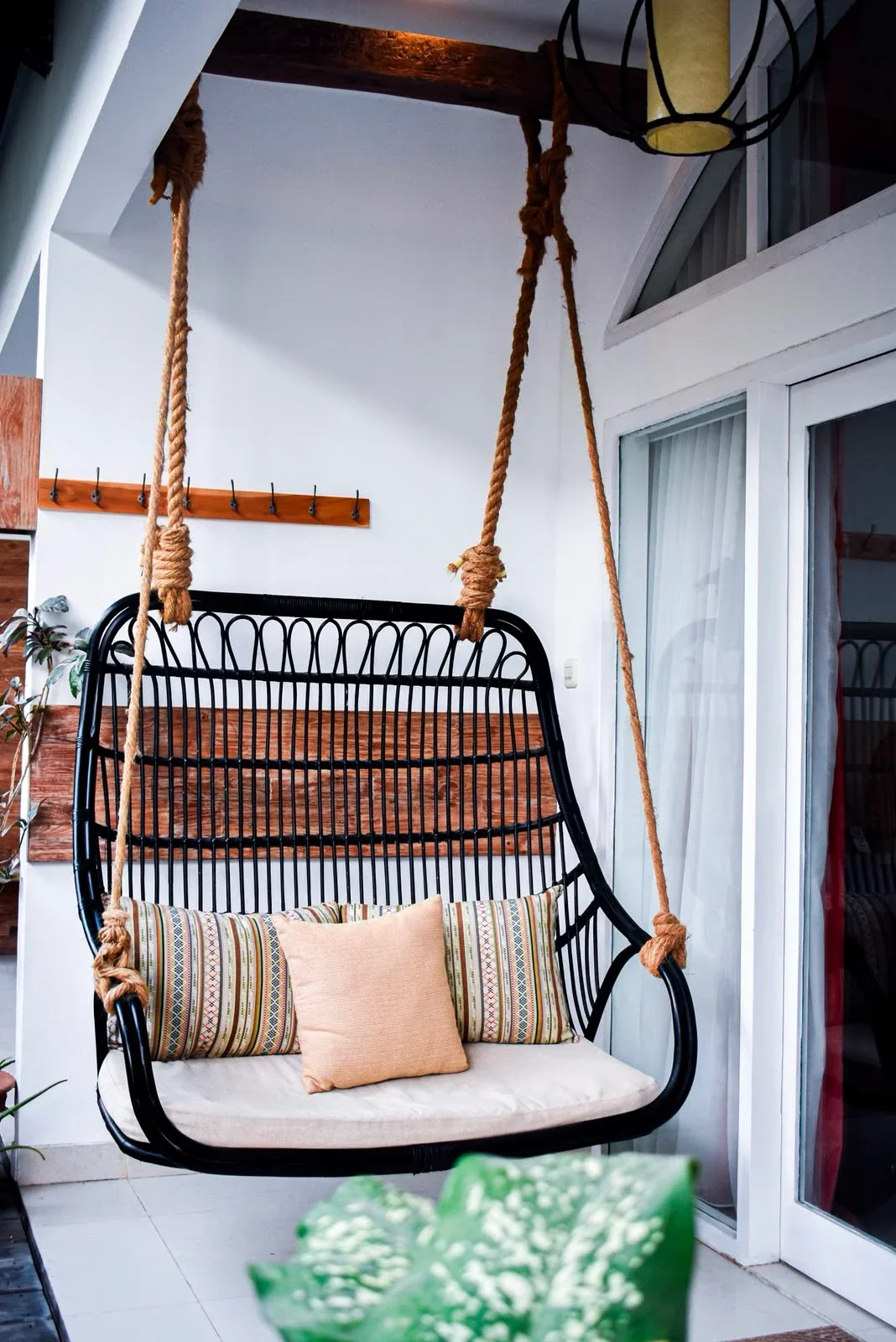 Hanging chair with cushions on a private guest room terrace