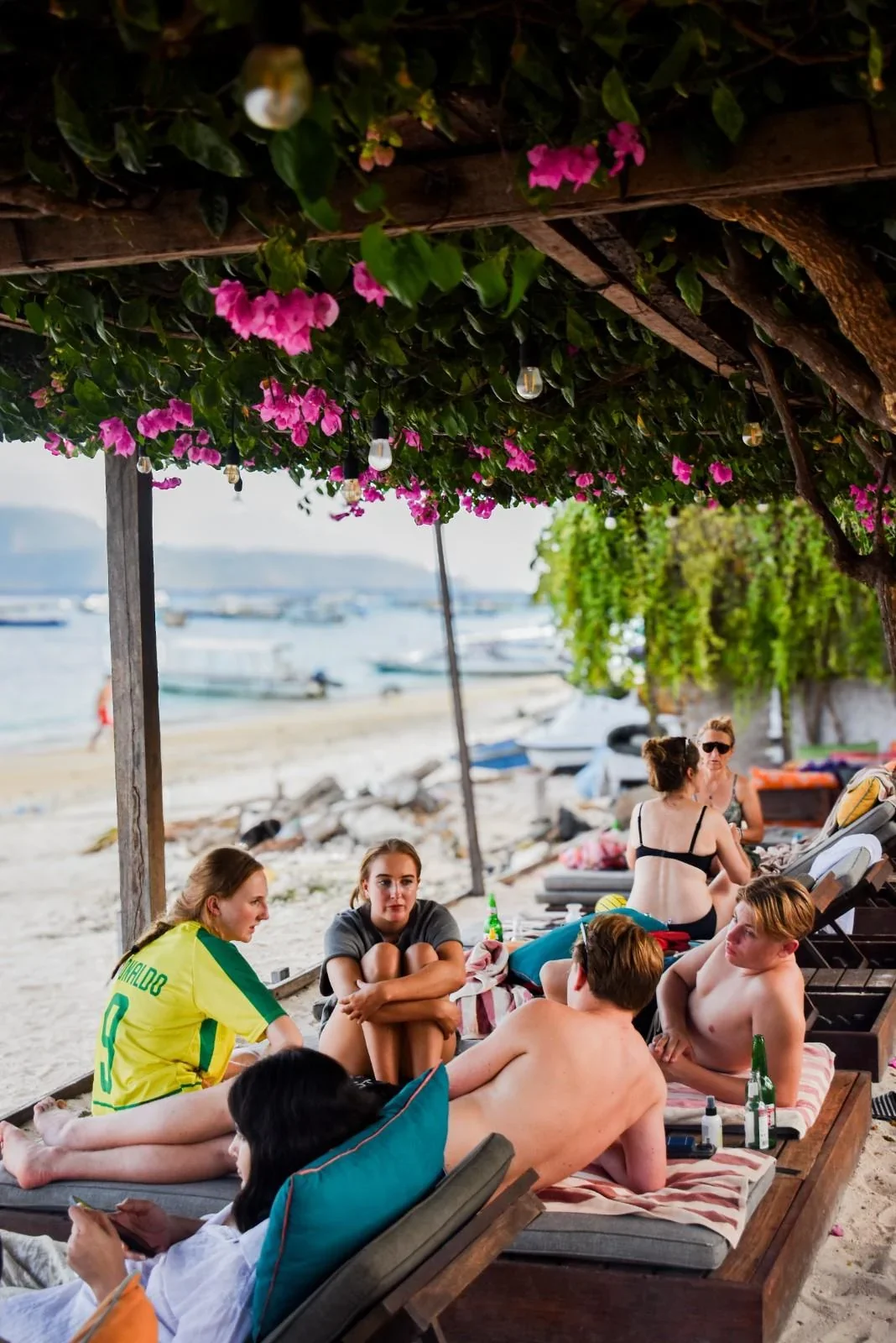 Travelers relaxing at a beachfront café on Gili Trawangan during the late afternoon