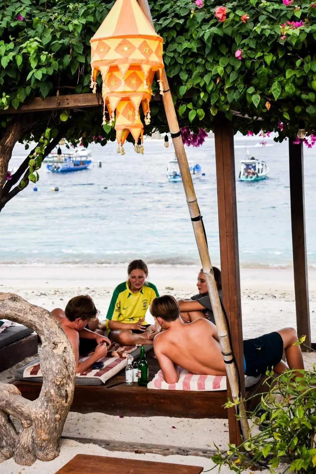 Friends relaxing at a beachfront lounge on Gili Trawangan after a day of island exploring