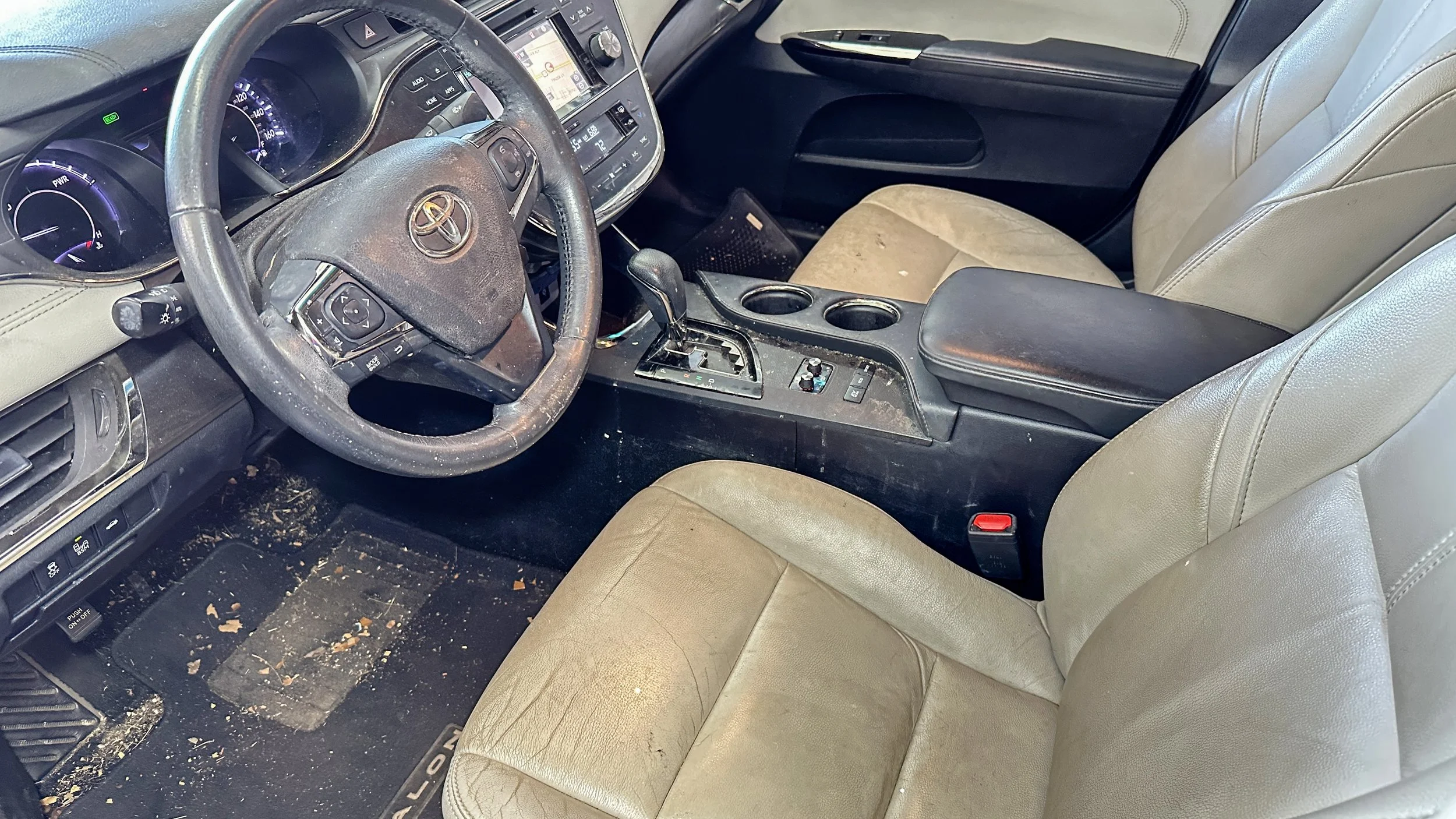 Interior detailing before treatment showing stained upholstery and debris at Luxdream Car Detailing in Louisville, Kentucky.