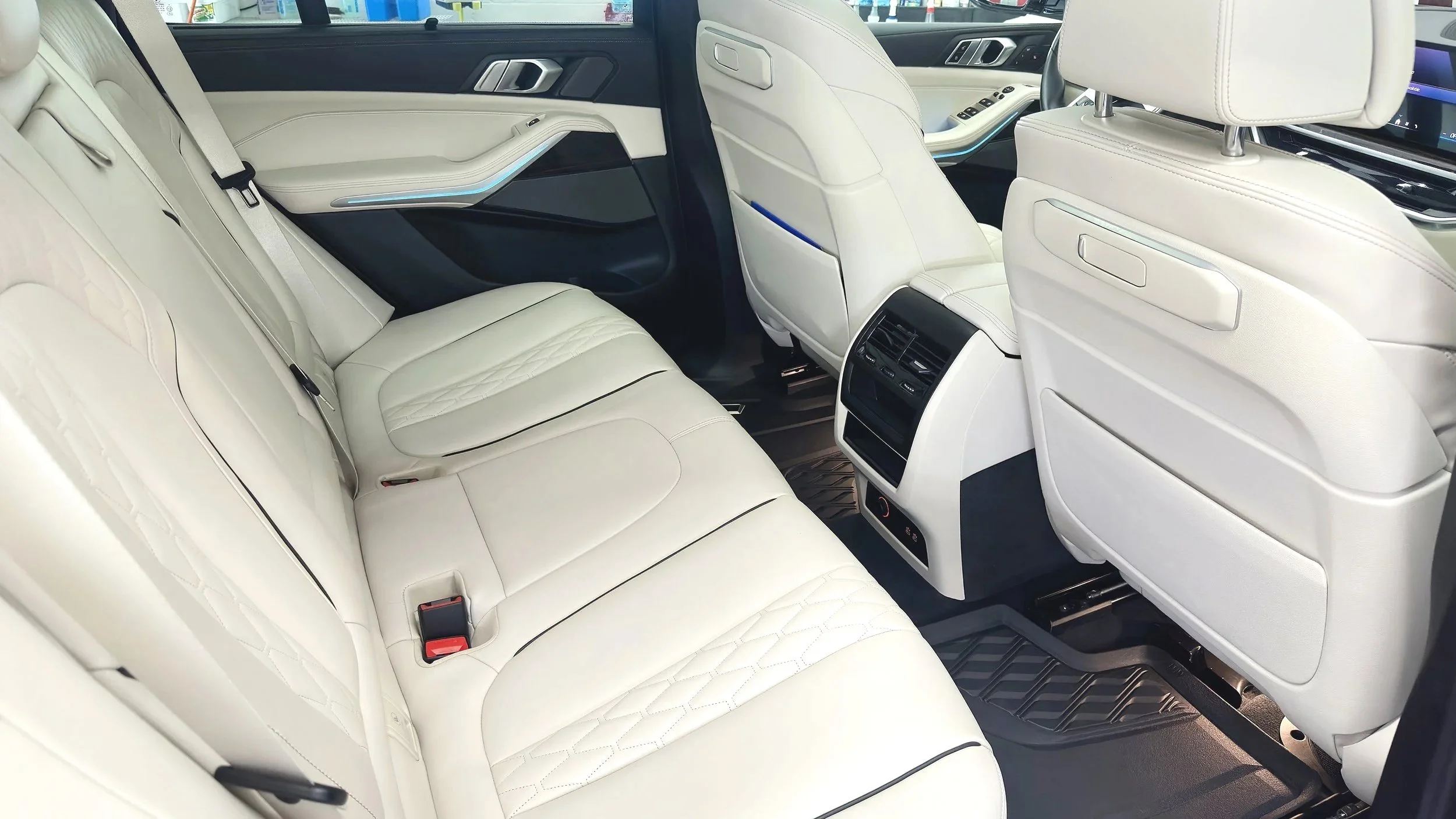 Interior of a luxury BMW vehicle with cream leather seats, black accent, Luxdream Car Detailing, Louisville Ky