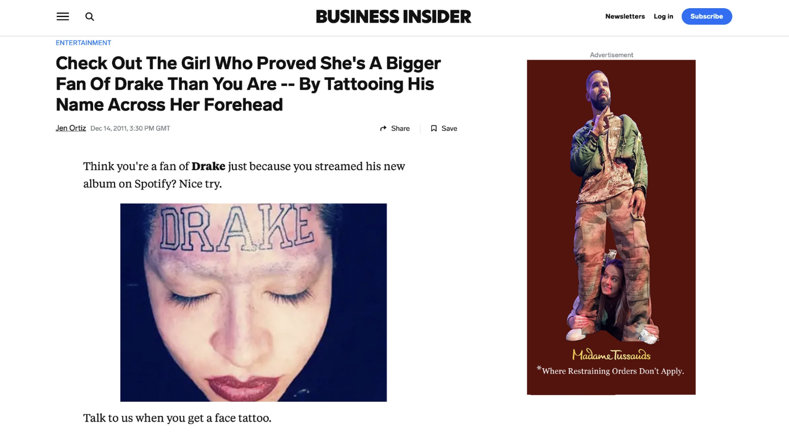 A woman with a face tattoo that says "DRAKE" on her forehead and closed eyes.