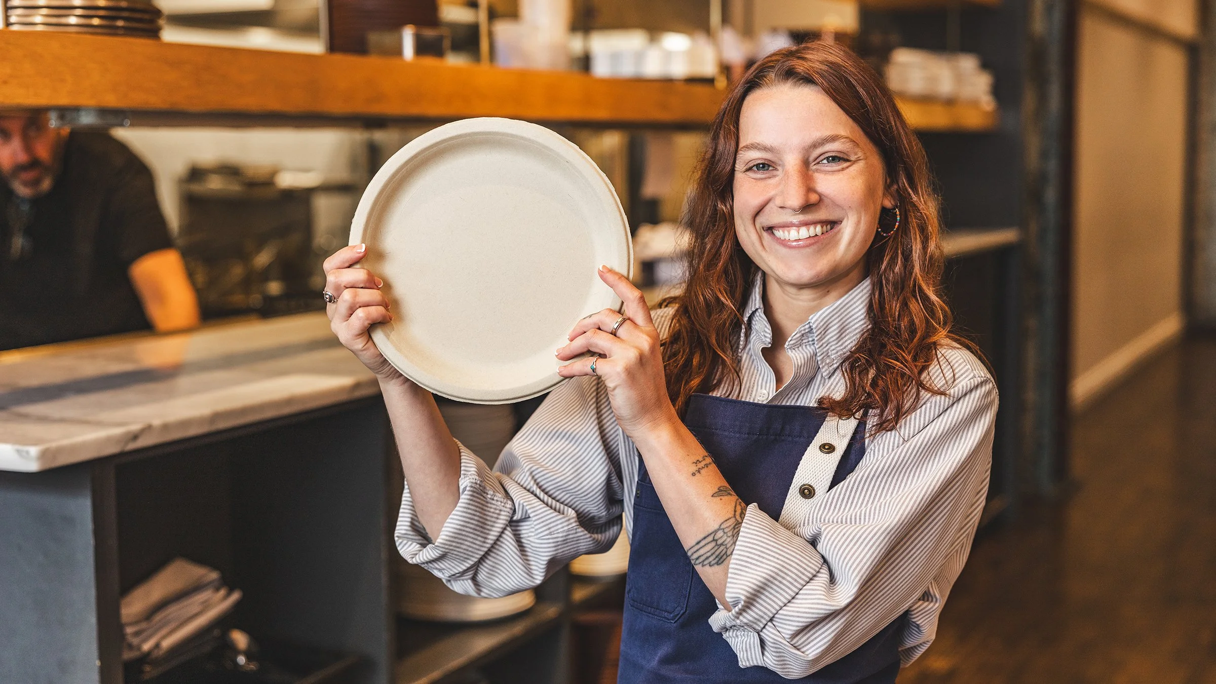 Chef holding a Terravive compostable foodservice plate made in the USA