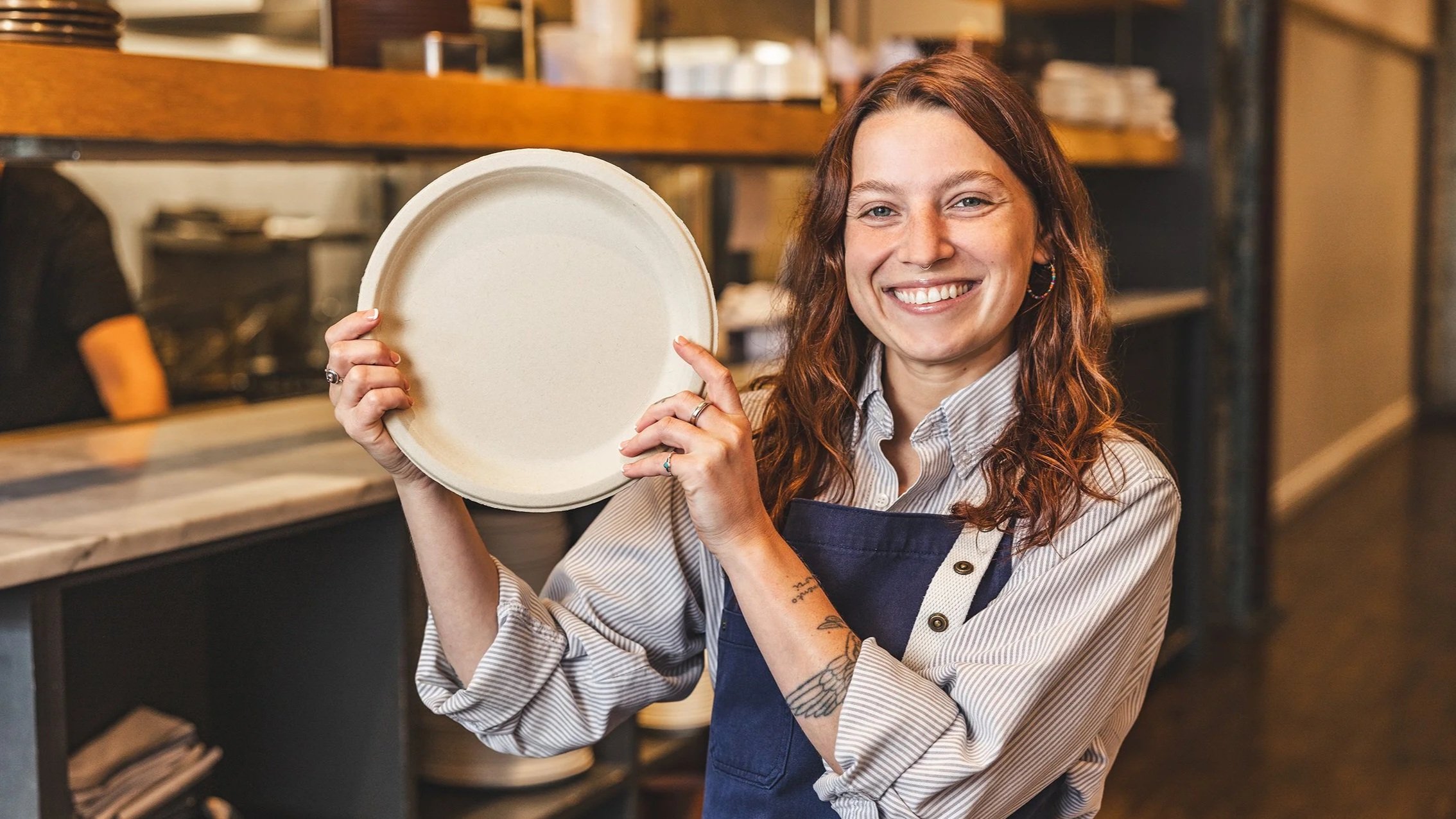 Bartender holding a Terravive compostable foodservice plate