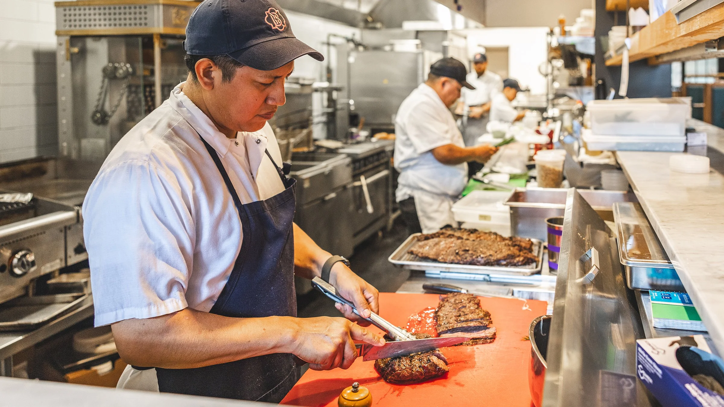 Chefs cooking steak in a commercial kitchen using Terravive foodservice products