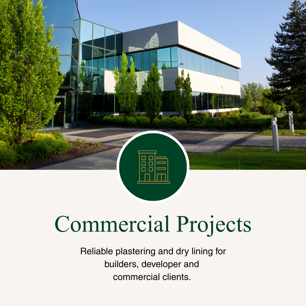 A modern office building with large glass windows surrounded by greenery and a paved walkway.