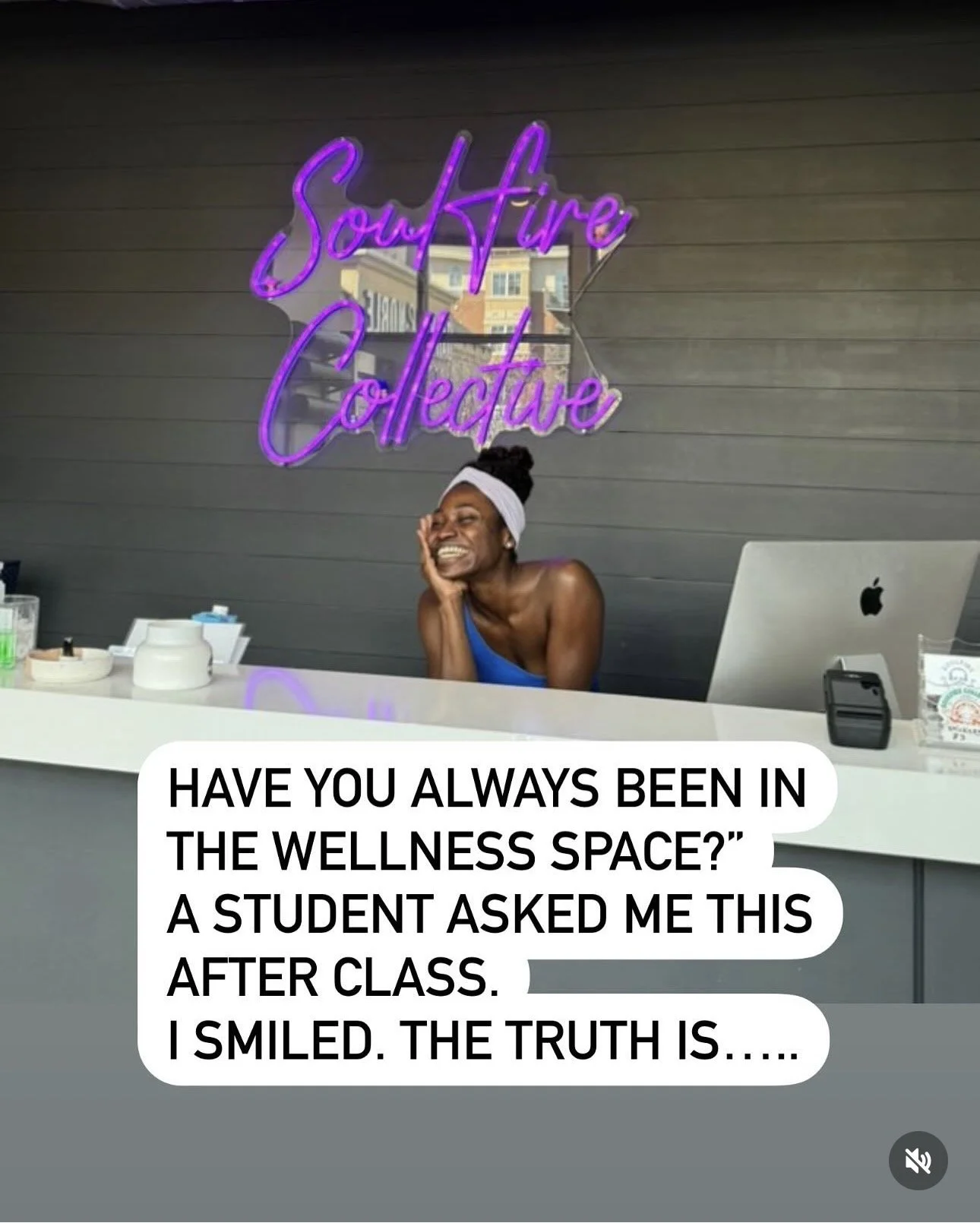 A woman smiling and sitting at a reception desk with a computer. Behind her is a neon sign that reads 'Soul Fire Collective'. There is a caption that says, 'Have you always been in the wellness space?' A student asked me this after class. I smiled. The truth is.....'