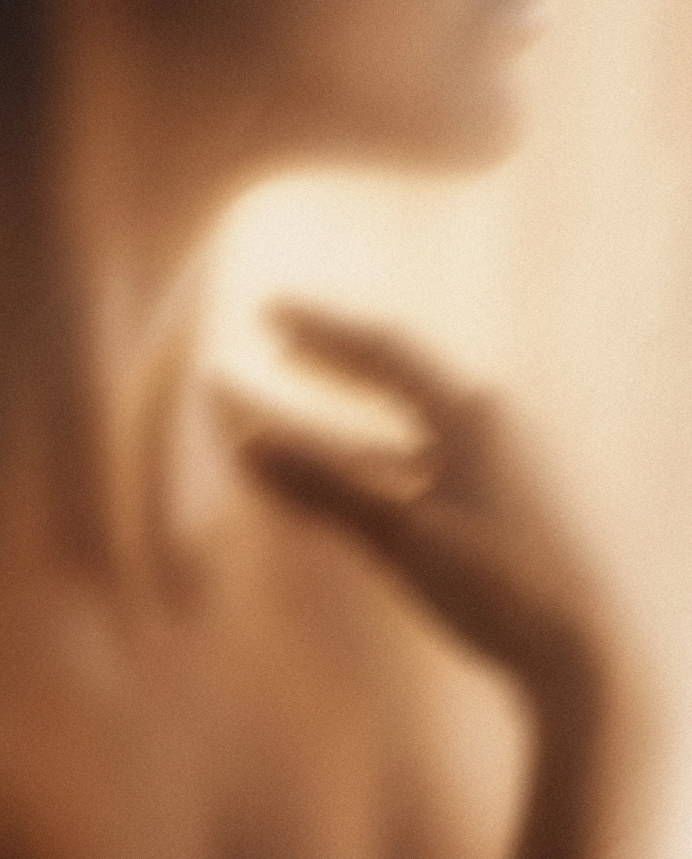 Close-up of a person's face, showing the nose and lips, with soft lighting and warm tones.
