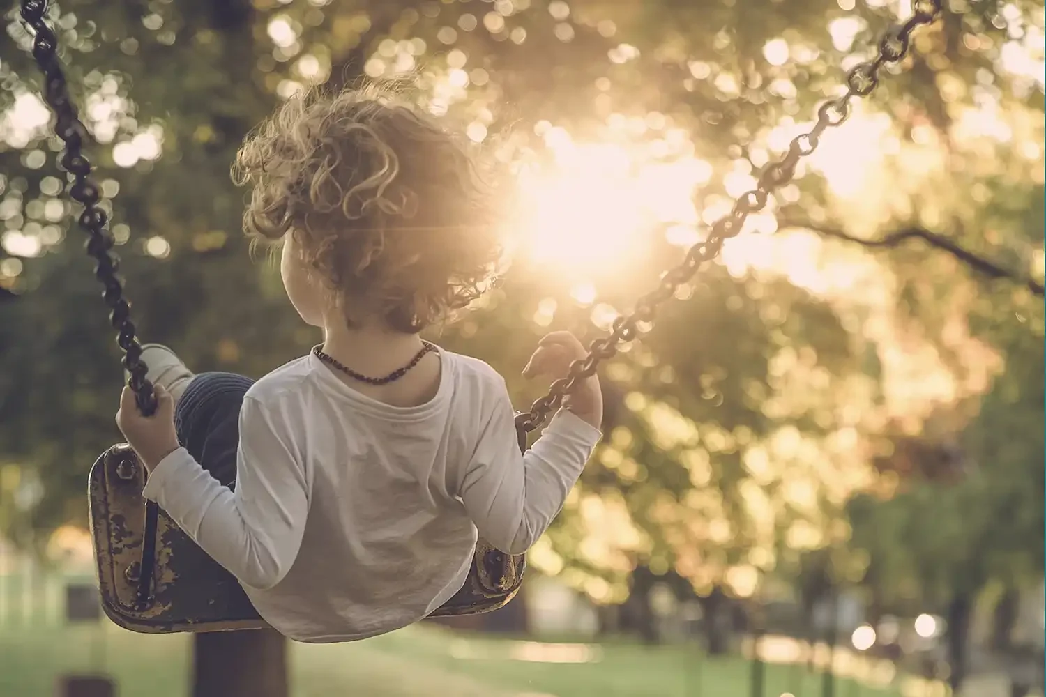niño en una hamaca con el sol de frente
