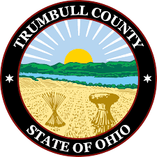 Seal of Trumbull County, Ohio featuring a sunrise over fields and hills.