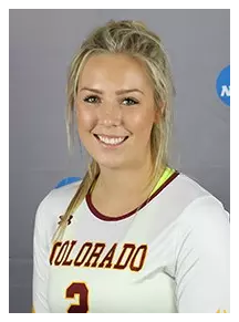 A young woman with blonde hair in a ponytail, smiling, wearing a USC volleyball jersey with the number 2, standing against a gray background.