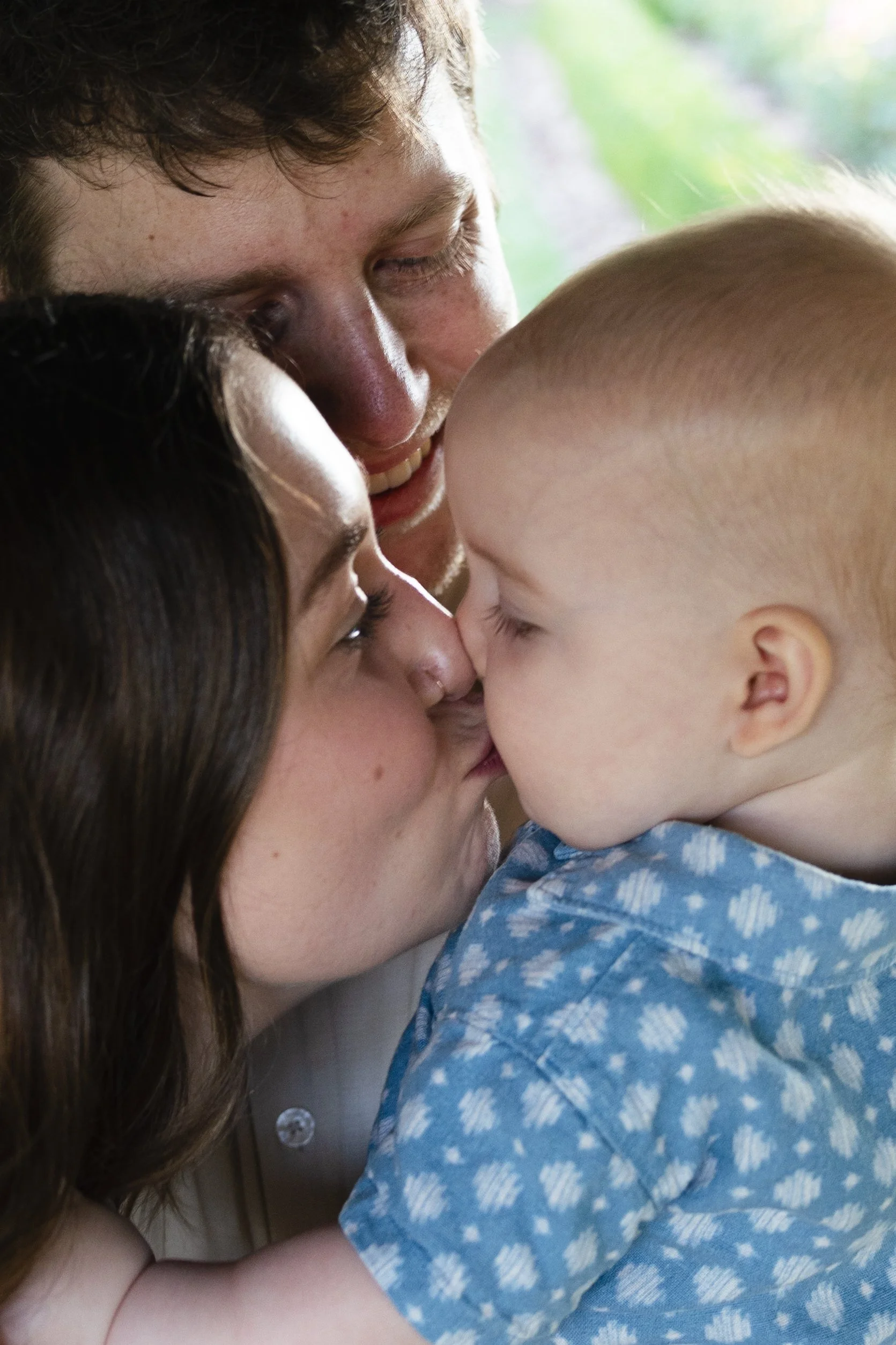 A woman and a young child sharing a close, affectionate moment, touching their foreheads together.