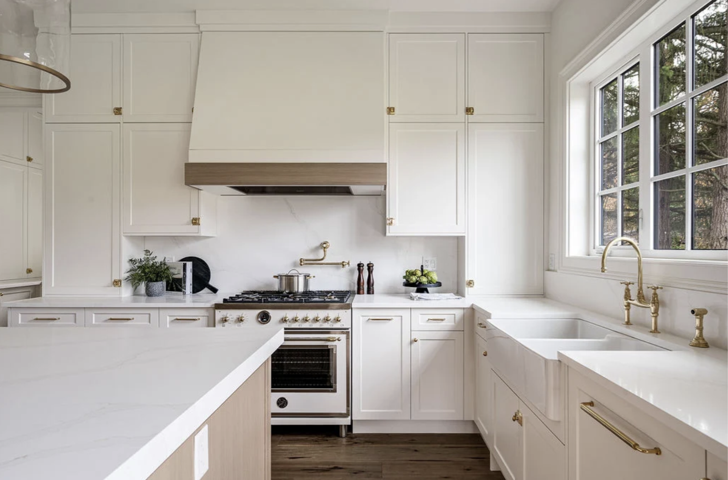 Rendering of the kitchen and dining area with a wood ceiling beam, island pendants and a wood dining table