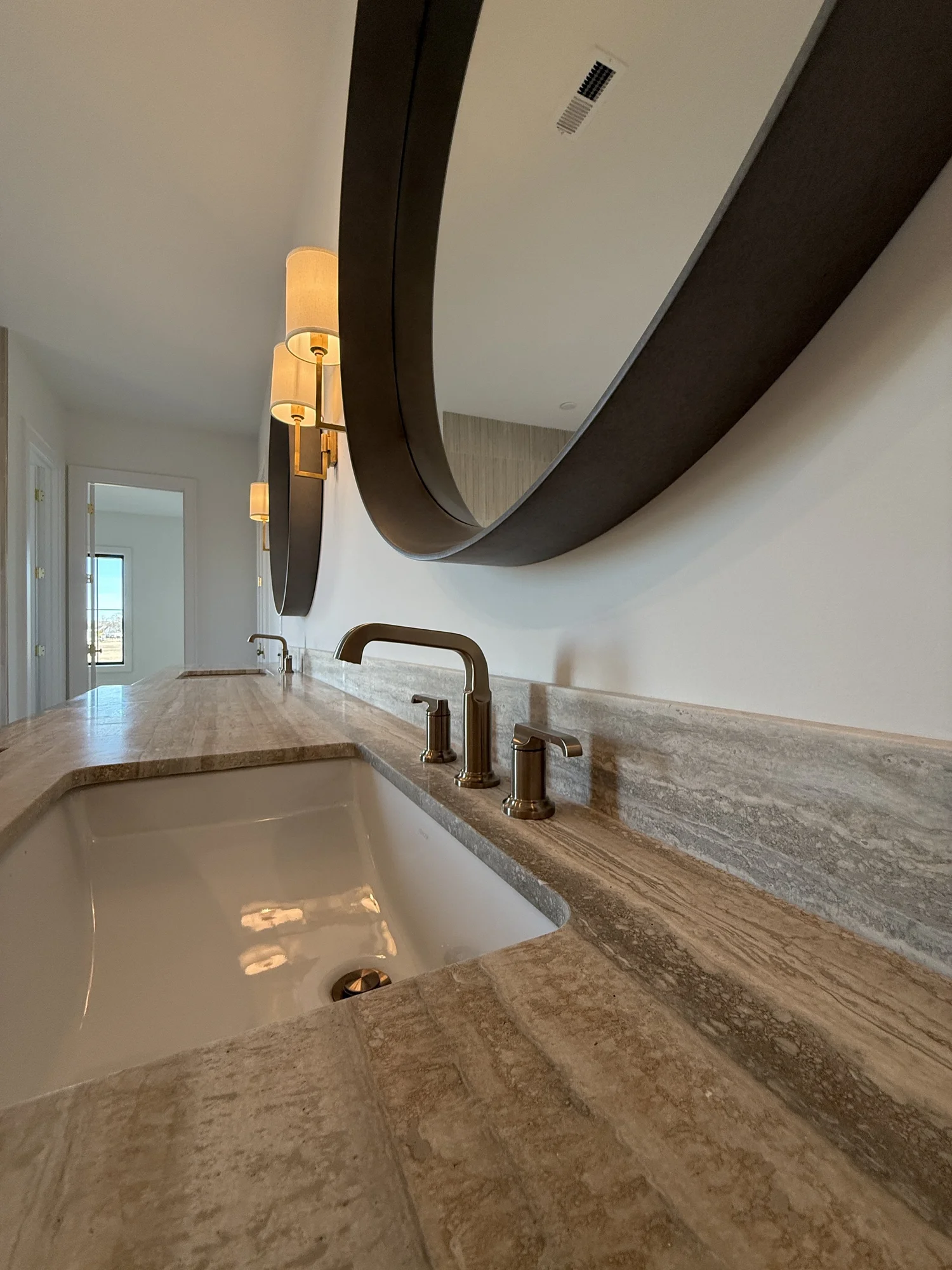 Primary bath vanity detail with undermount sink and bronze faucet