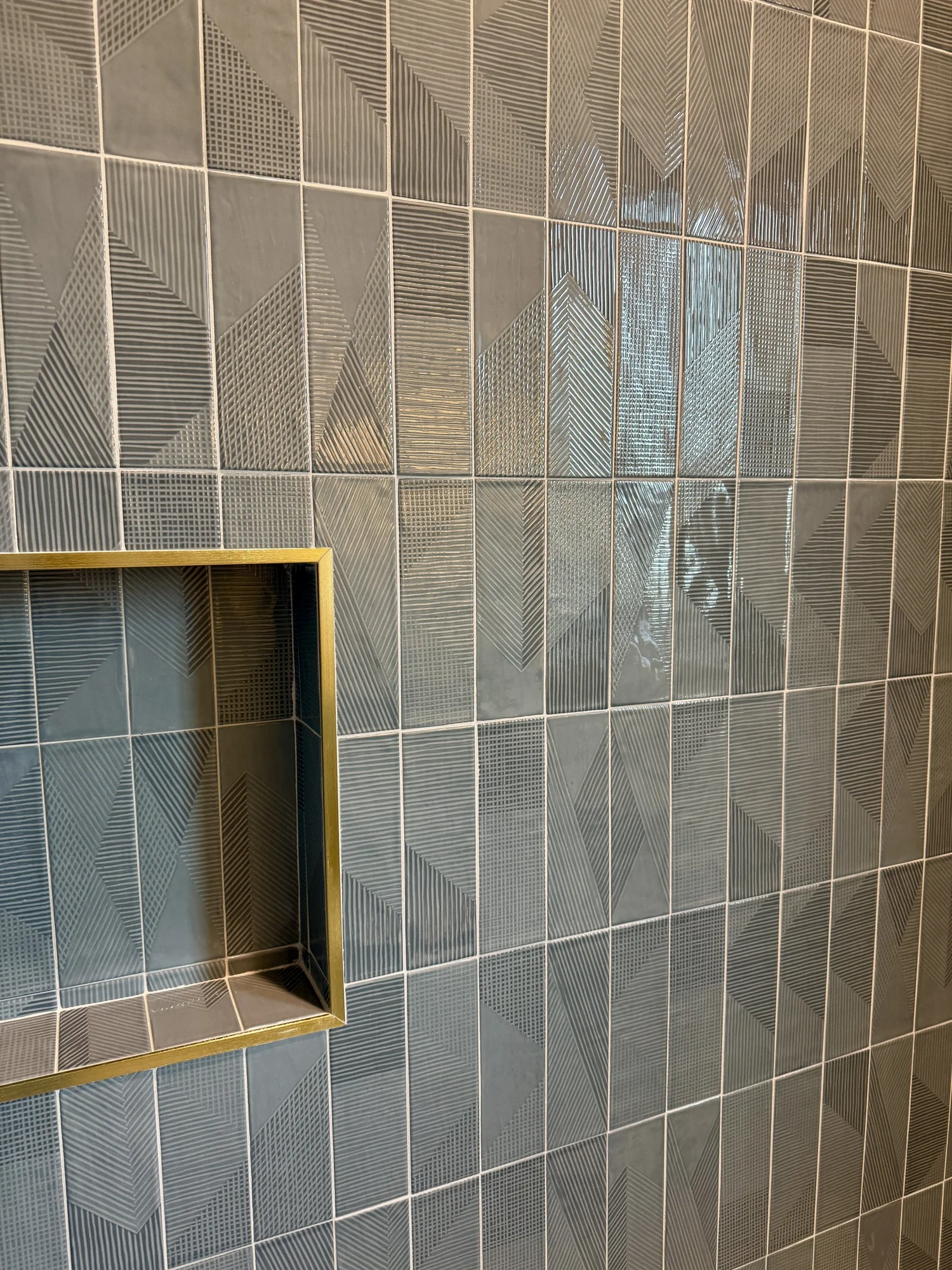 Textured blue-green tile with a recessed shower niche