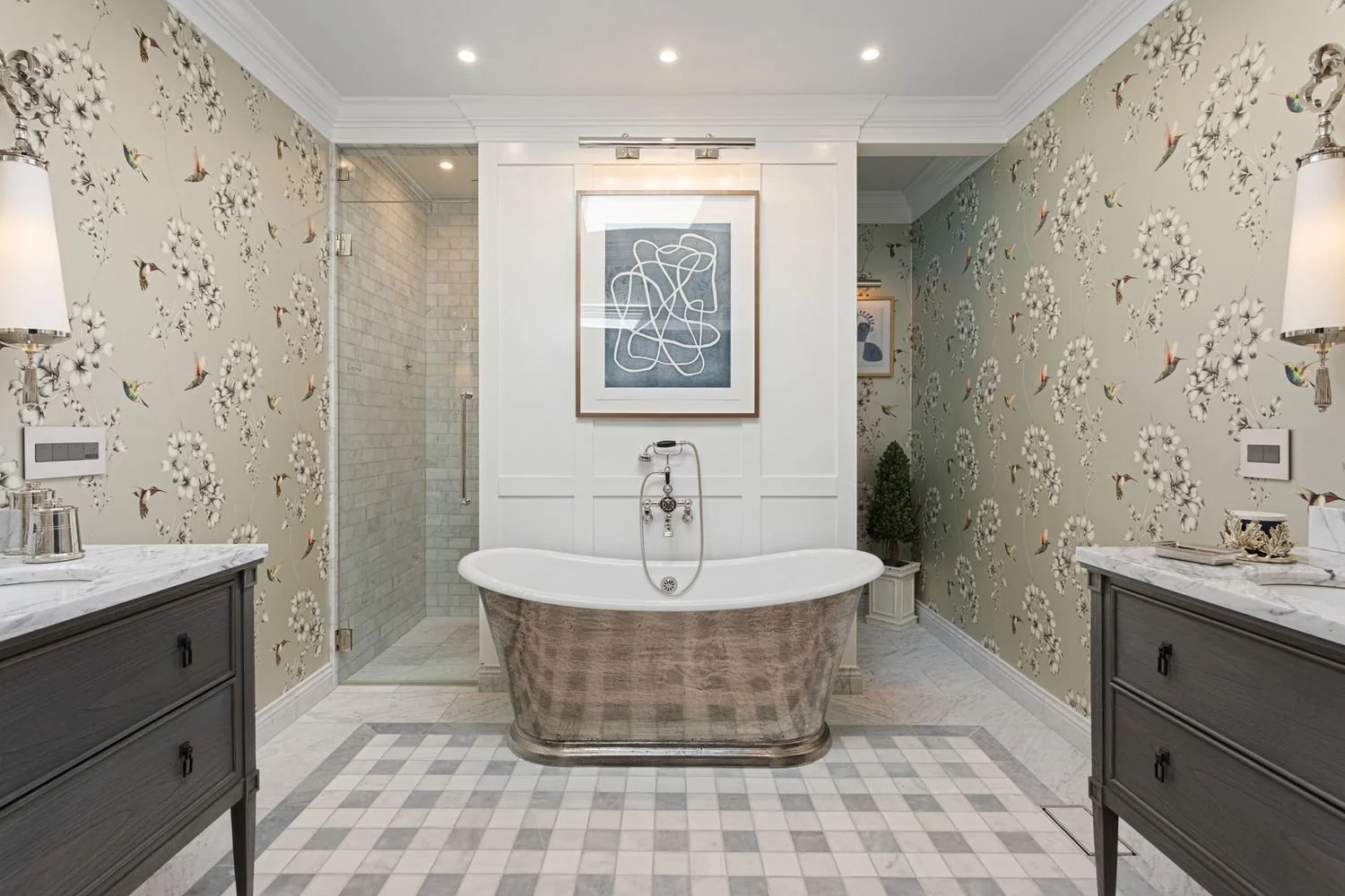 Primary bath with a freestanding soaking tub between two vanities