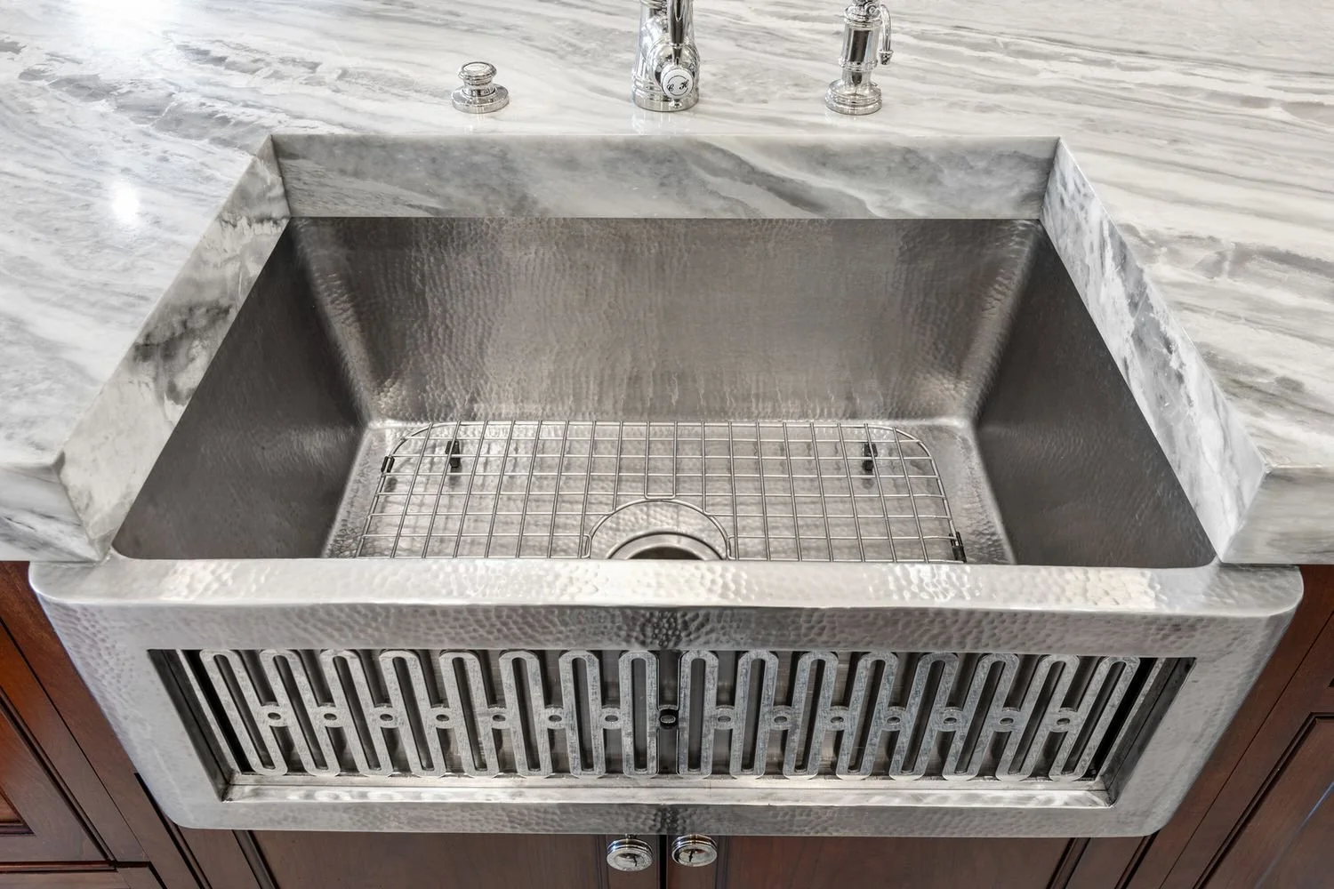 Farmhouse sink set in a marble countertop
