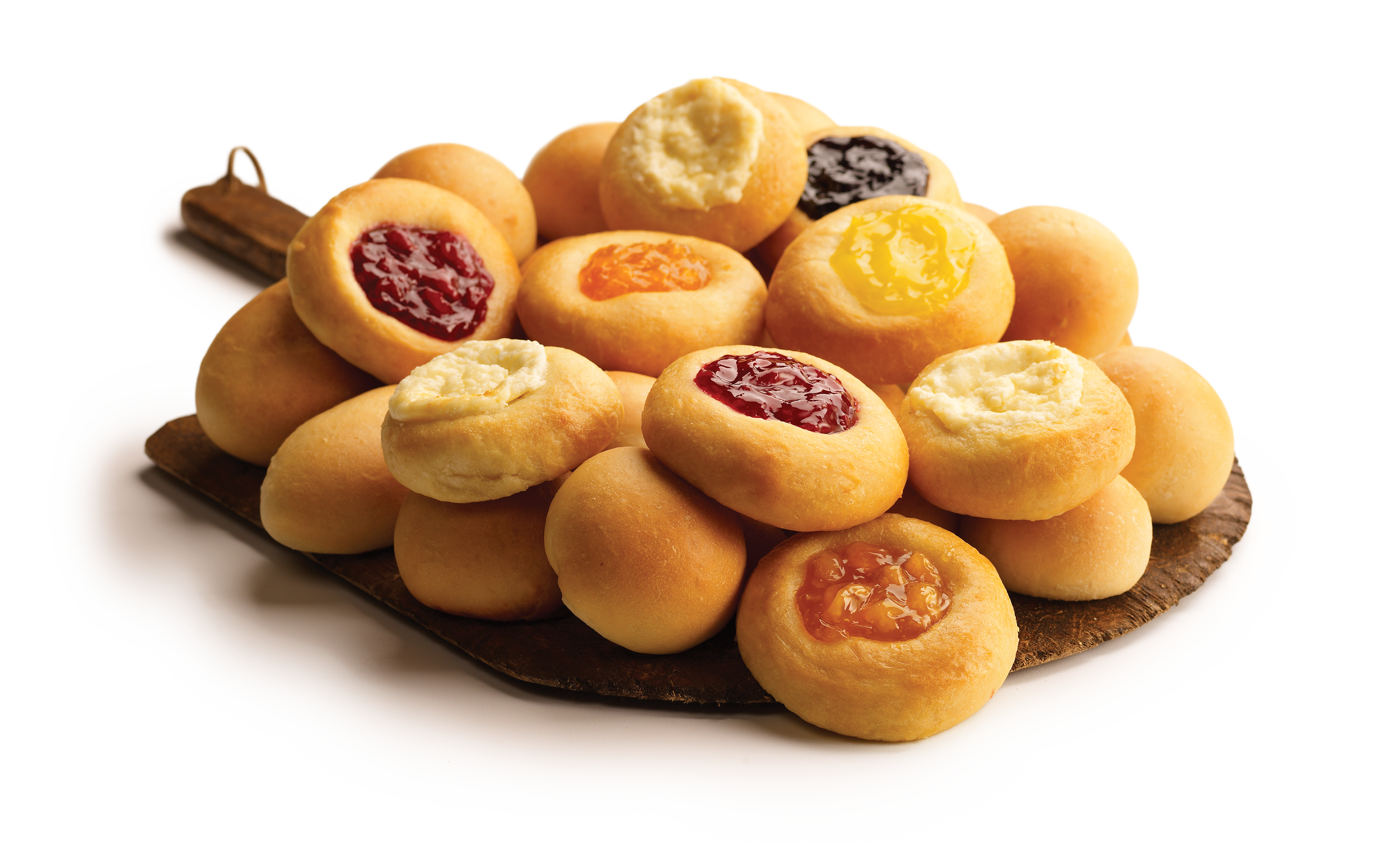 Assorted mini fruit-filled cookies on a wooden tray
