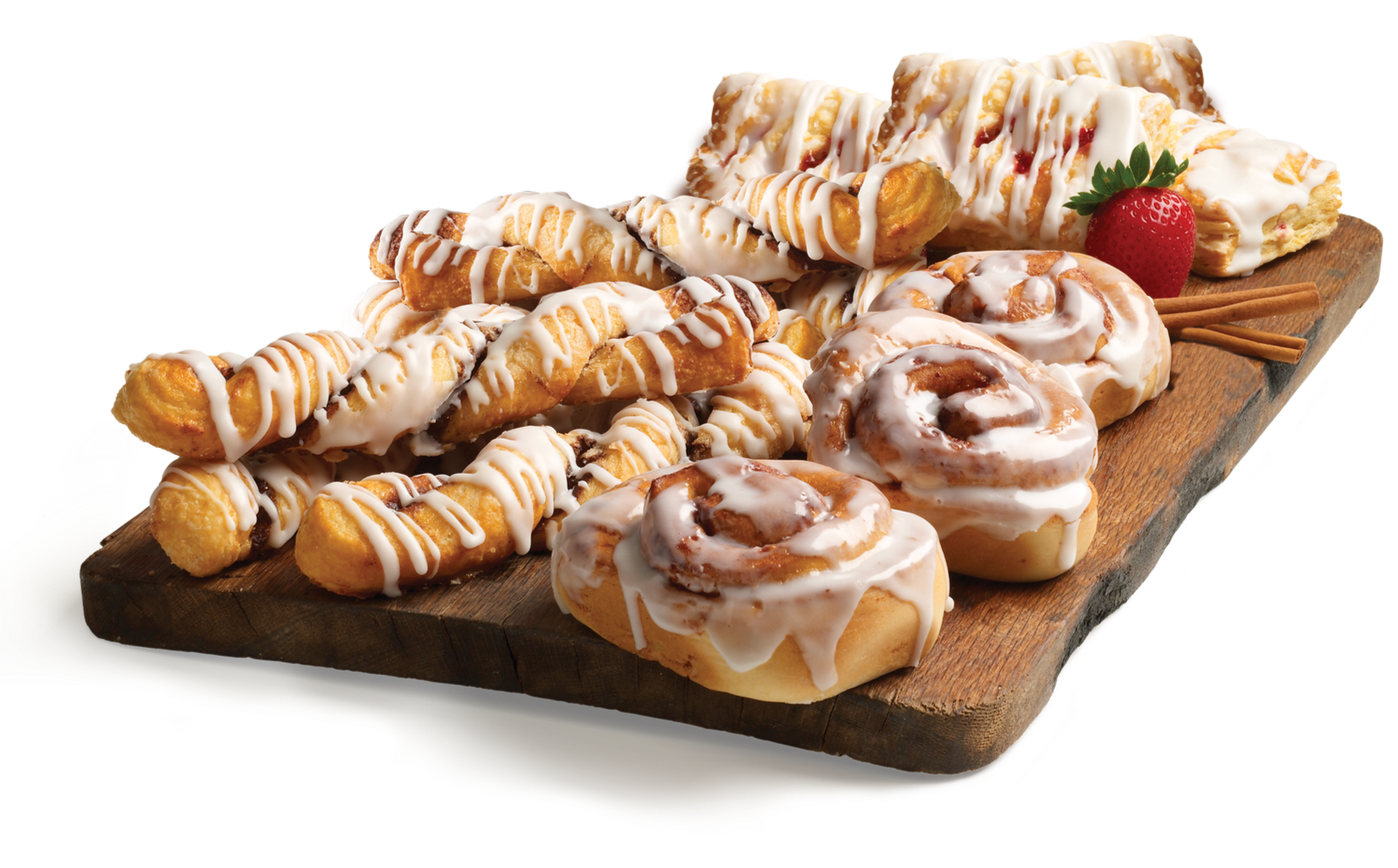 Assorted cinnamon rolls and fried churros drizzled with white icing on a wooden serving board, garnished with a strawberry and cinnamon sticks.