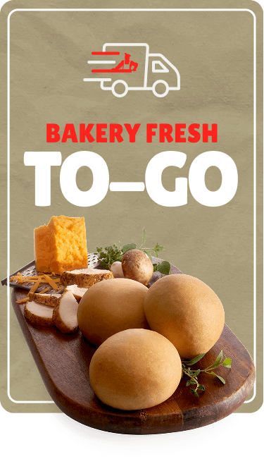 Bakery fresh to-go sign with a graphic of a delivery truck, featuring fresh bread, eggs, and herbs on a wooden serving board.