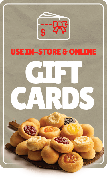 Sign promoting gift cards for in-store and online use, with an image of assorted fruit and cream cheese Kolaches.