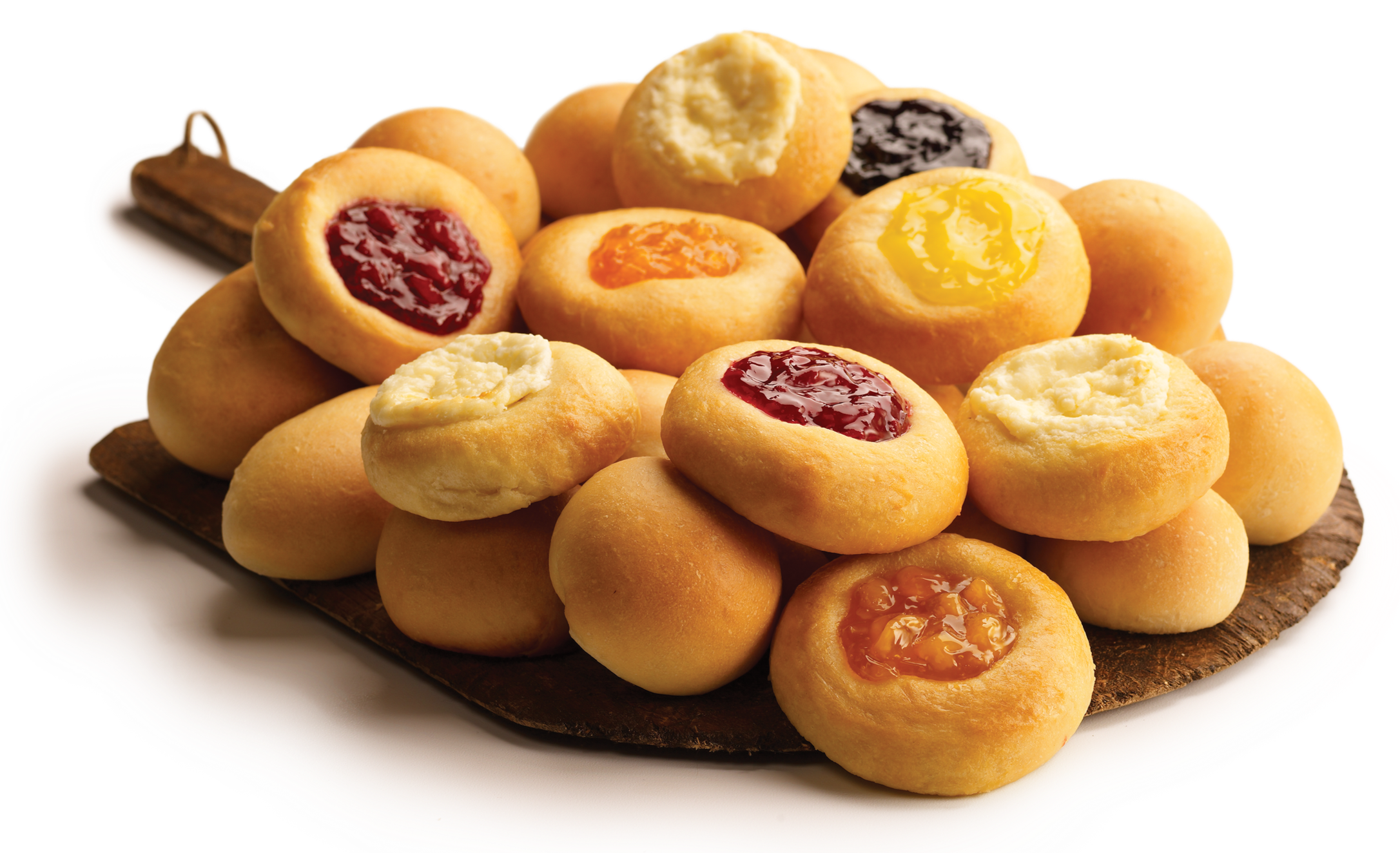 A plate of assorted bite-sized cookies with various fruit-flavored fillings, arranged on a wooden serving board.