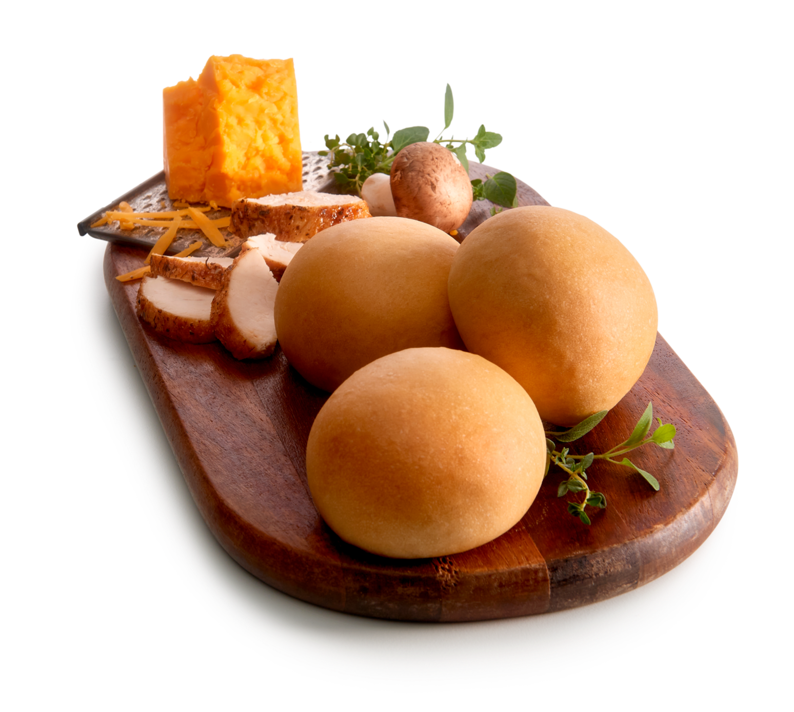 Three kolaches on a wooden board with chicken, cheese and mushrooms.