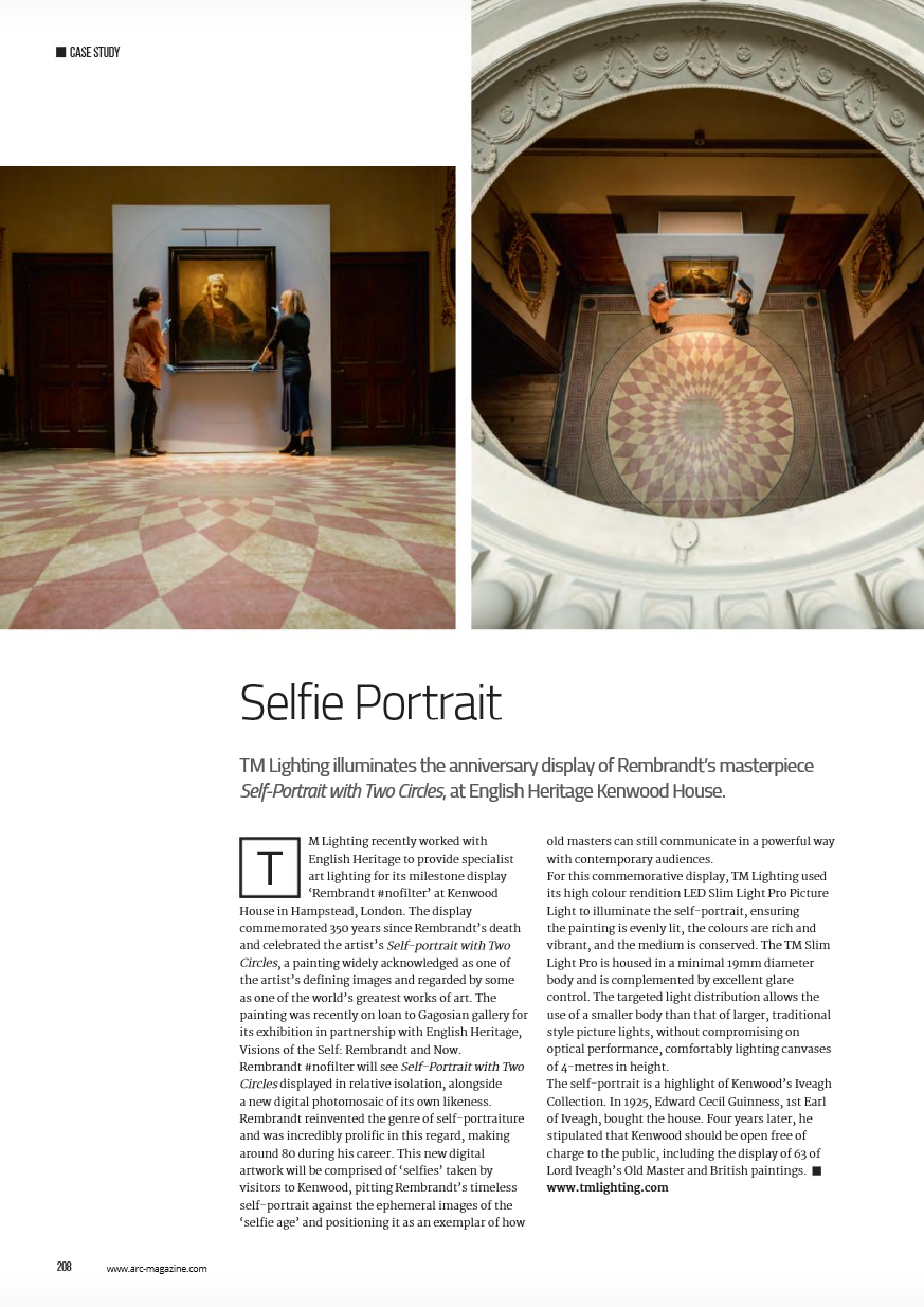 People taking a selfie portrait of a painting in an art gallery, viewed from above.