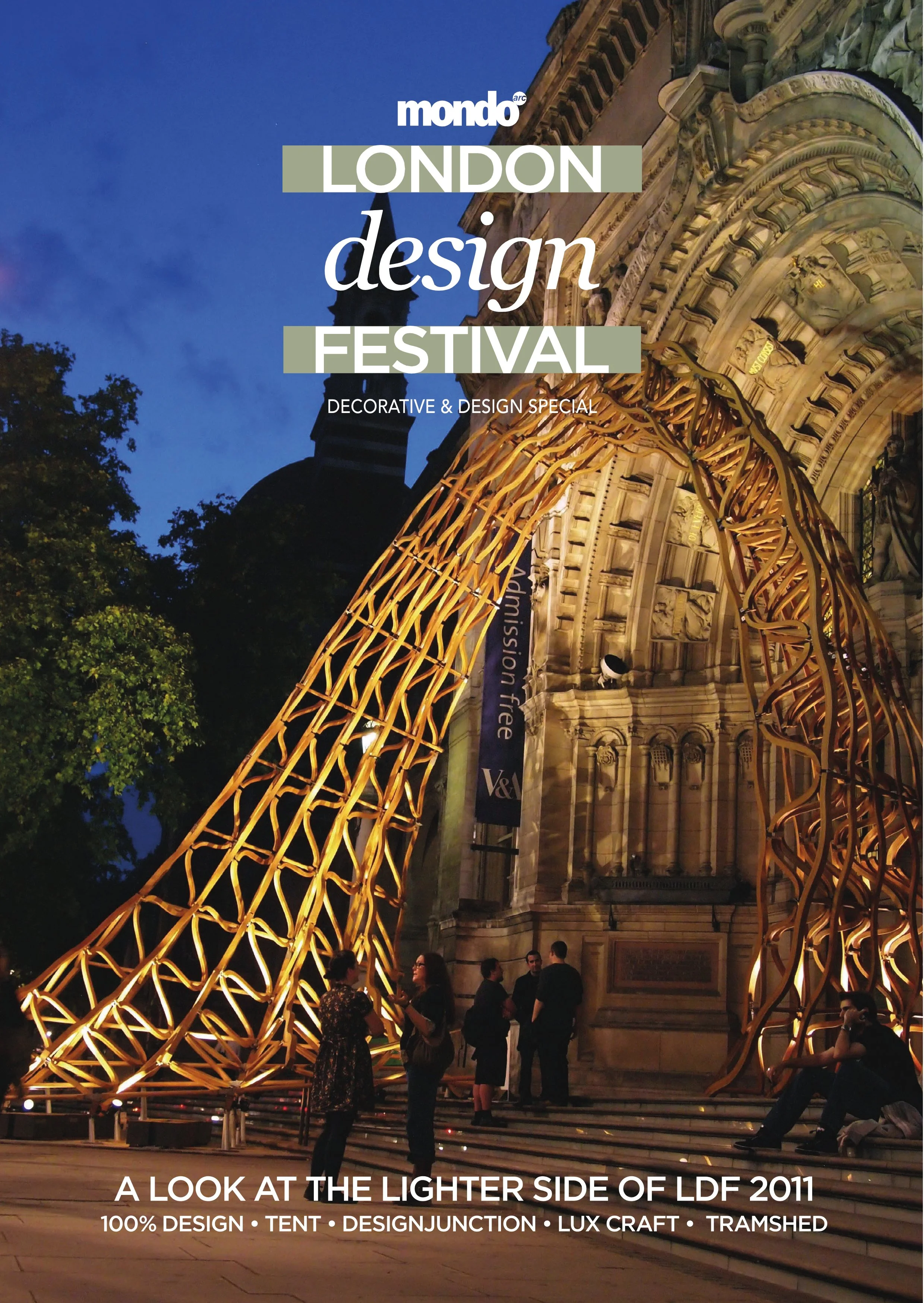 People standing and sitting in front of an illuminated architectural building with a large, artistic, lighted sculpture in the foreground during the evening at the London Design Festival 2011.