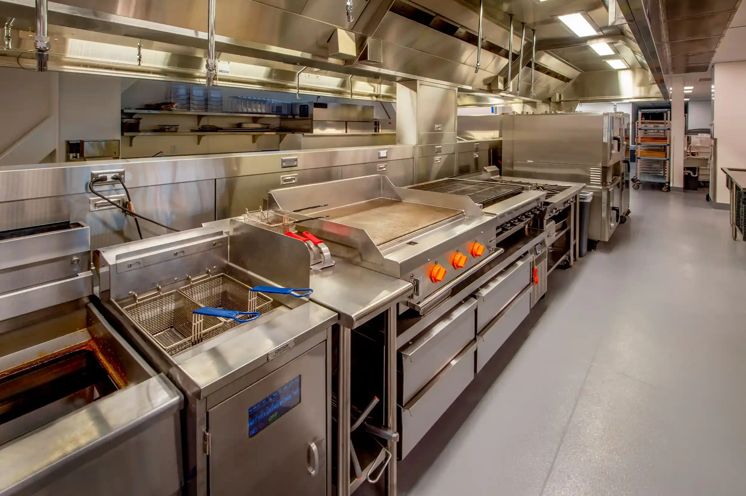 deep fryer and griddle in commercial kitchen