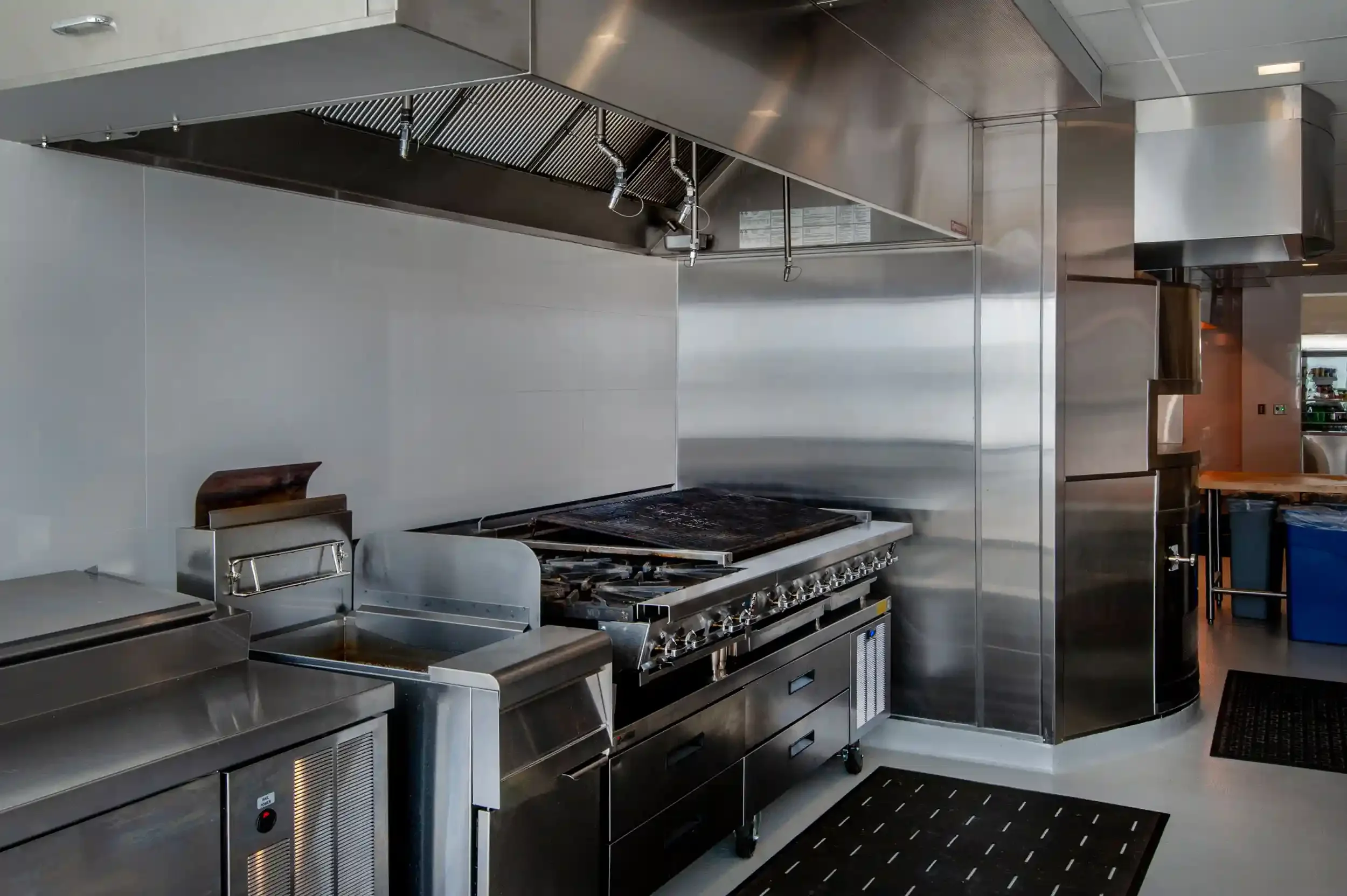 stove and ventilation hood in a commercial kitchen