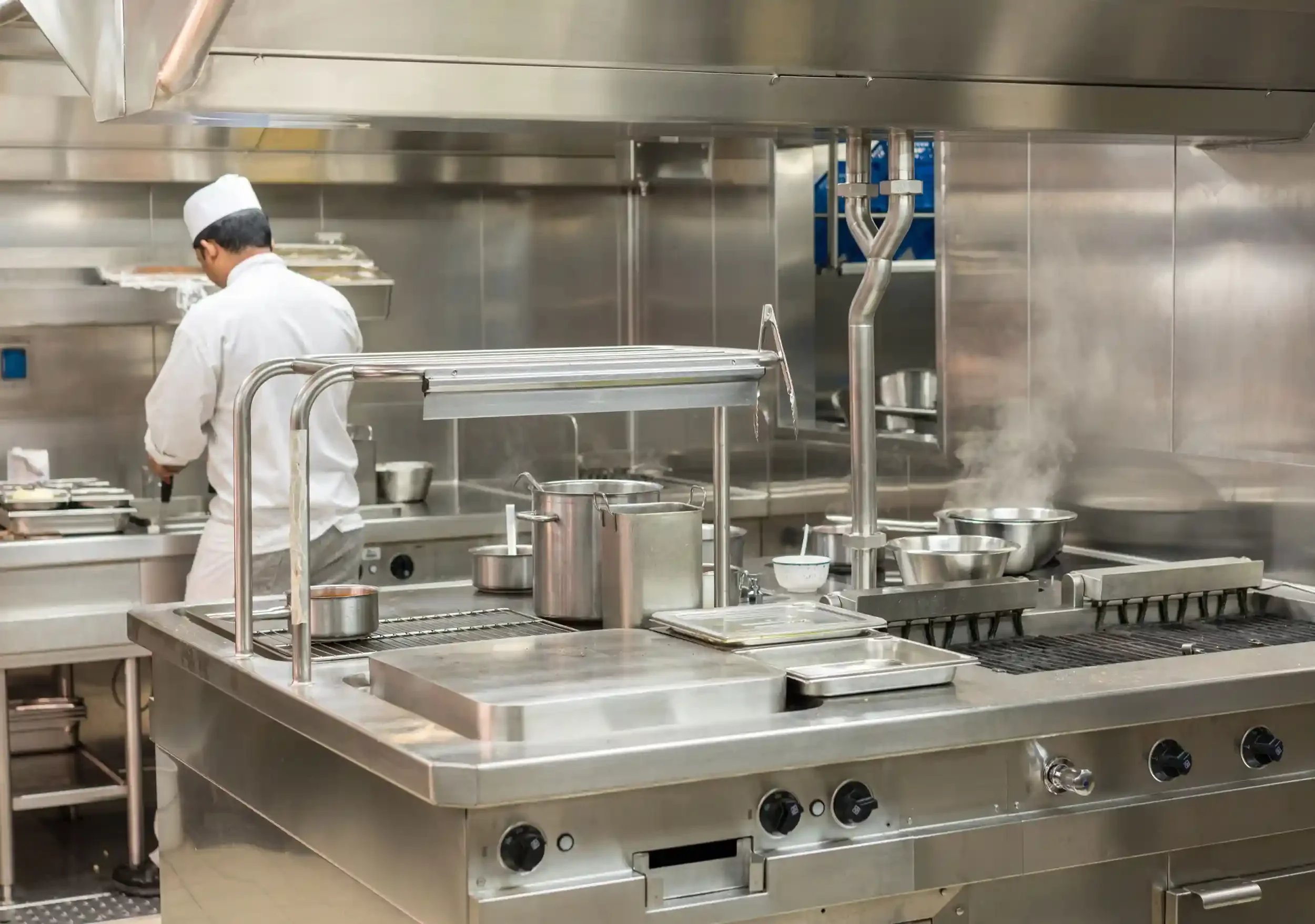 commercial kitchen with chef cooking