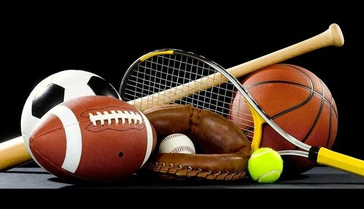 Collection of sports equipment including a soccer ball, football, baseball, baseball glove, tennis ball, basketball, badminton racket, and tennis racket, arranged on a black background.